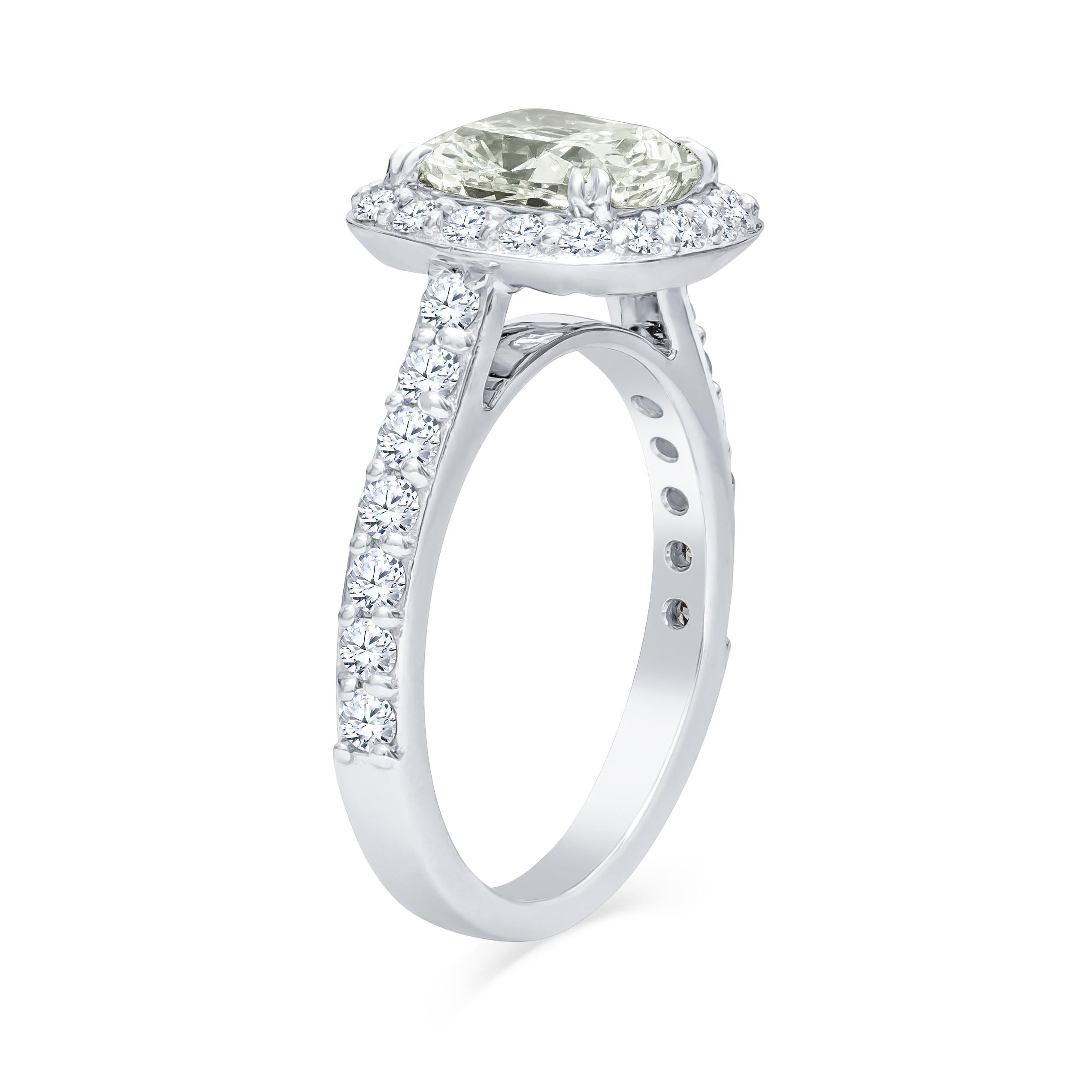 18K white gold cathedral diamond engagement ring with a 2.28 carat cushion cut natural light green diamond and 0.88 carats total weight in round brilliant cut diamonds. This rare green diamond is light in color but is a very bright, vibrant gem. The