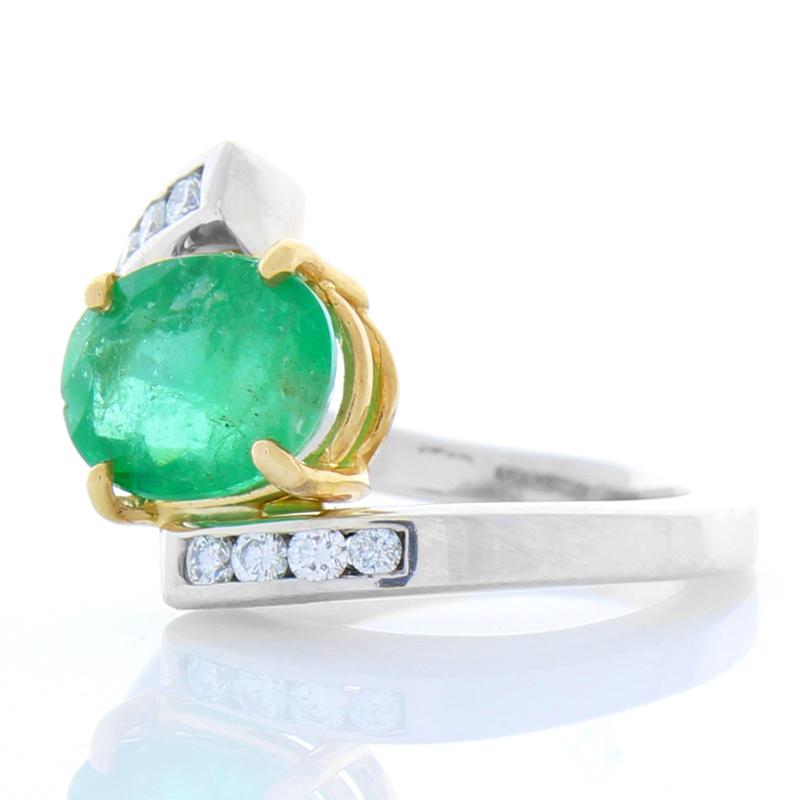 Stylish and sophisticated, an emerald and diamond ring is always a remarkable way to make a big impact. This stunning ring features a gorgeous 2.28 carat oval green emerald from Zambia. It is set in yellow gold, which enhances the rich color of the