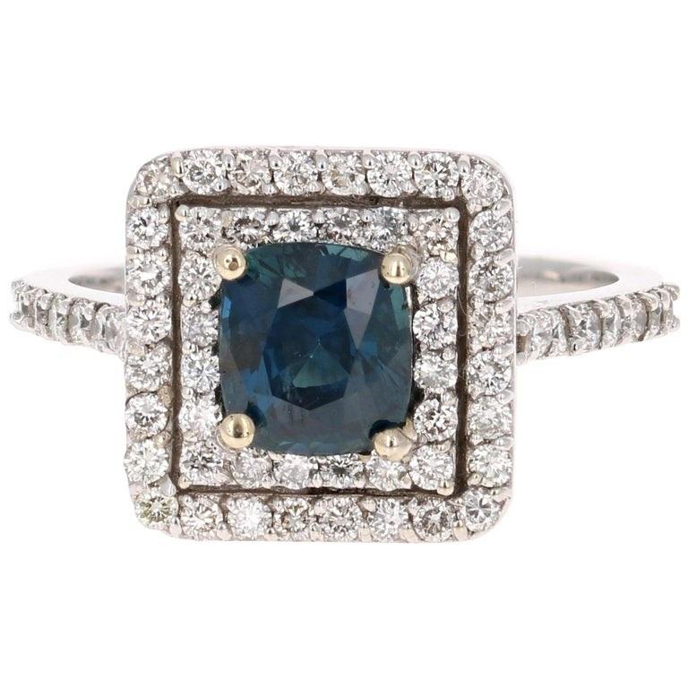 Stunning alternative to a regular diamond engagement ring! 

This blazing blue sapphire ring has a Cushion Cut 1.54 Carat Blue Sapphire and is surrounded by a double halo of 64 Round Cut Diamonds that weigh 0.75 Carats. The clarity and color of the