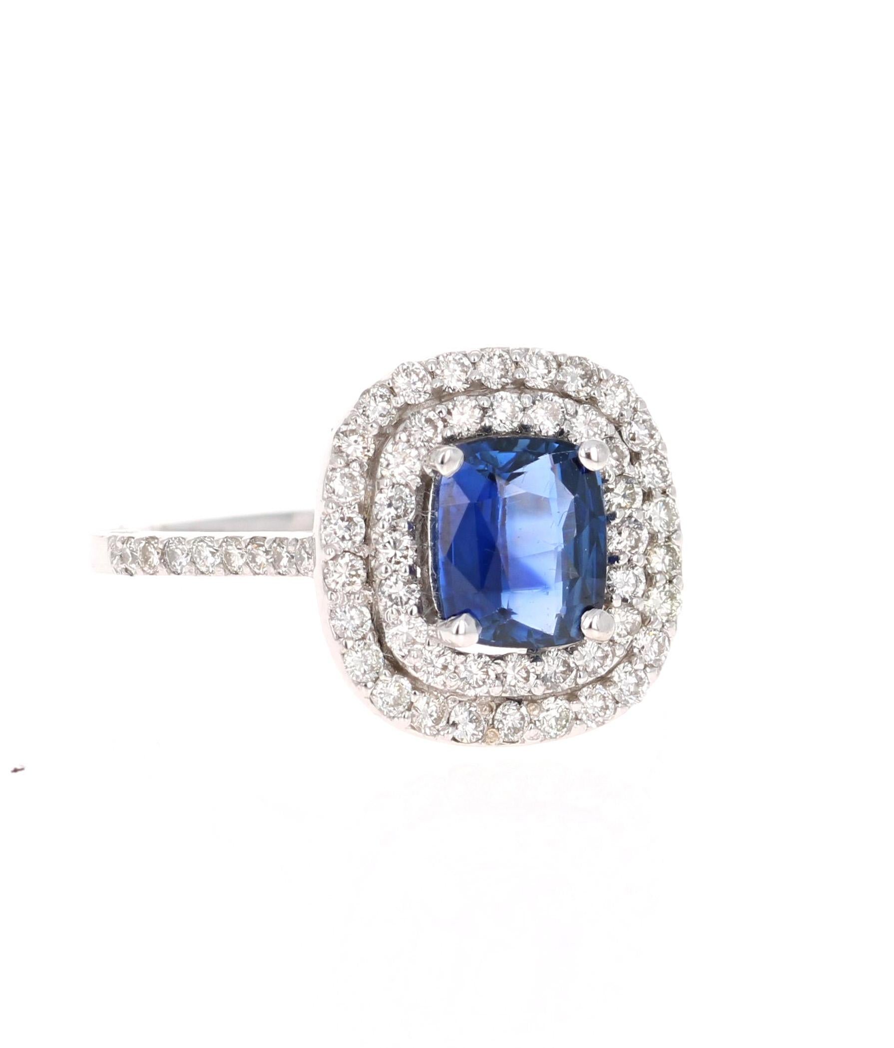 This blazing blue sapphire ring has a Oval Cushion Cut 1.51 Carat Blue Sapphire and is surrounded by a double halo of 62 Round Cut Diamonds that weigh 0.78 Carats. The clarity and color of the diamonds are VS-H. The total carat weight of the ring is