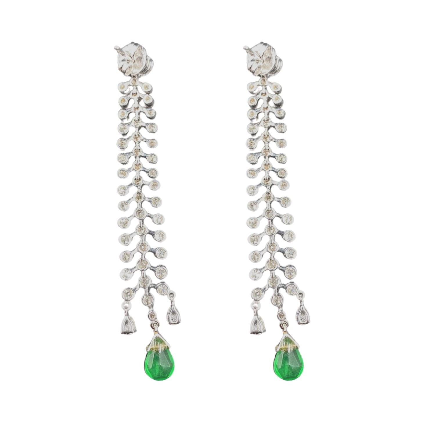 The Zamuri Earrings feature 3.64 carats of diamonds cascading effortlessly in a drop 2.29 carat natural emerald. 

Gems Stone Details
Round Brilliant Diamonds
Shape	Round
Color	G
Clarity 	VS1
Weight	3.64 carats 

Natural Emerald
Shape 	Pear Shaped