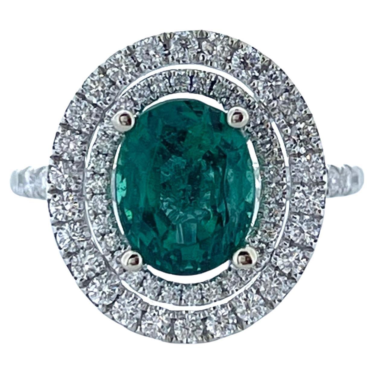 2.29 Carat Emerald Oval in Double Halo Diamond Ring in 18K White Gold For Sale