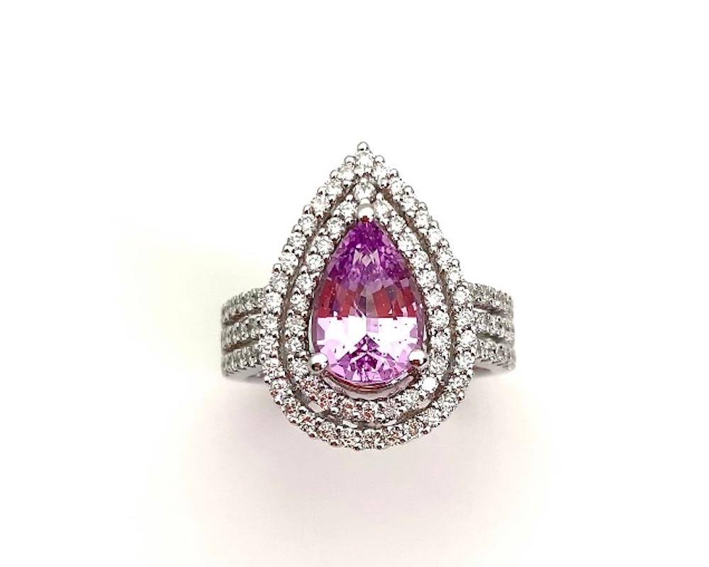 Lavender spinel are extremely unusual, especially one as bright and crystalline as this! This beautiful pear shaped gem is set with brilliant-cut white diamonds in a double 