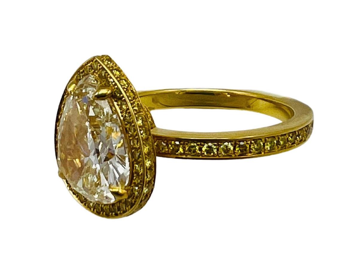 Product details:

The ring features 2.29 light fancy yellow color pear shape diamond VS1 clarity, detailed with 0.65 ct. round brilliant cut diamond , set in 18K yellow gold.

Measurements: 5/8” x ½”.
Ring Size: 5.75- 6.
Weight: 4.9 g.
Hallmarks: