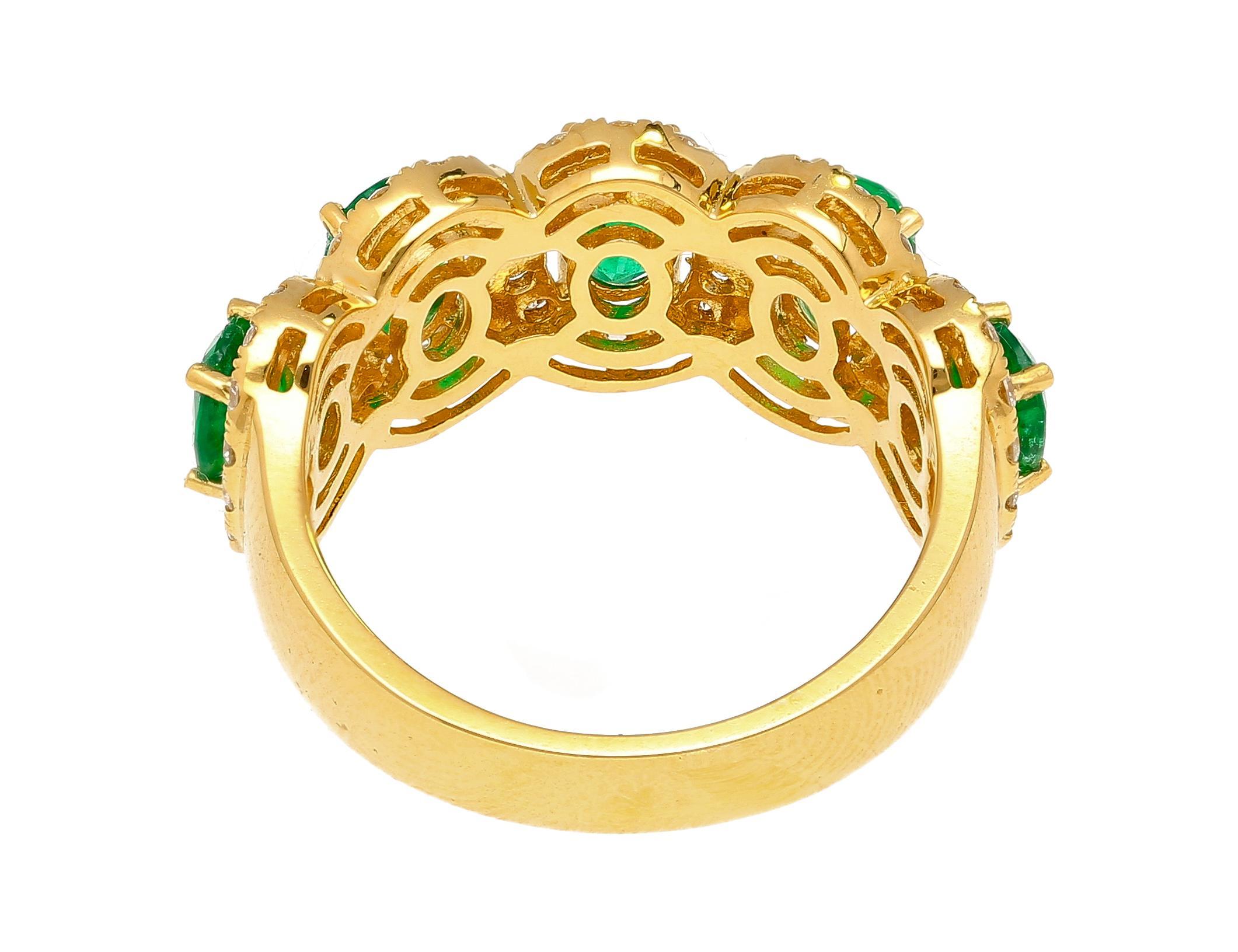 Natural Emerald and Diamond Wedding Band in 18k Solid Yellow Gold.

This wedding band contains 5 emerald stones. Each stone is oval-cut and they carry a total weight of 1.70 carats. Each emerald is adorned with a round cut white diamond halo,