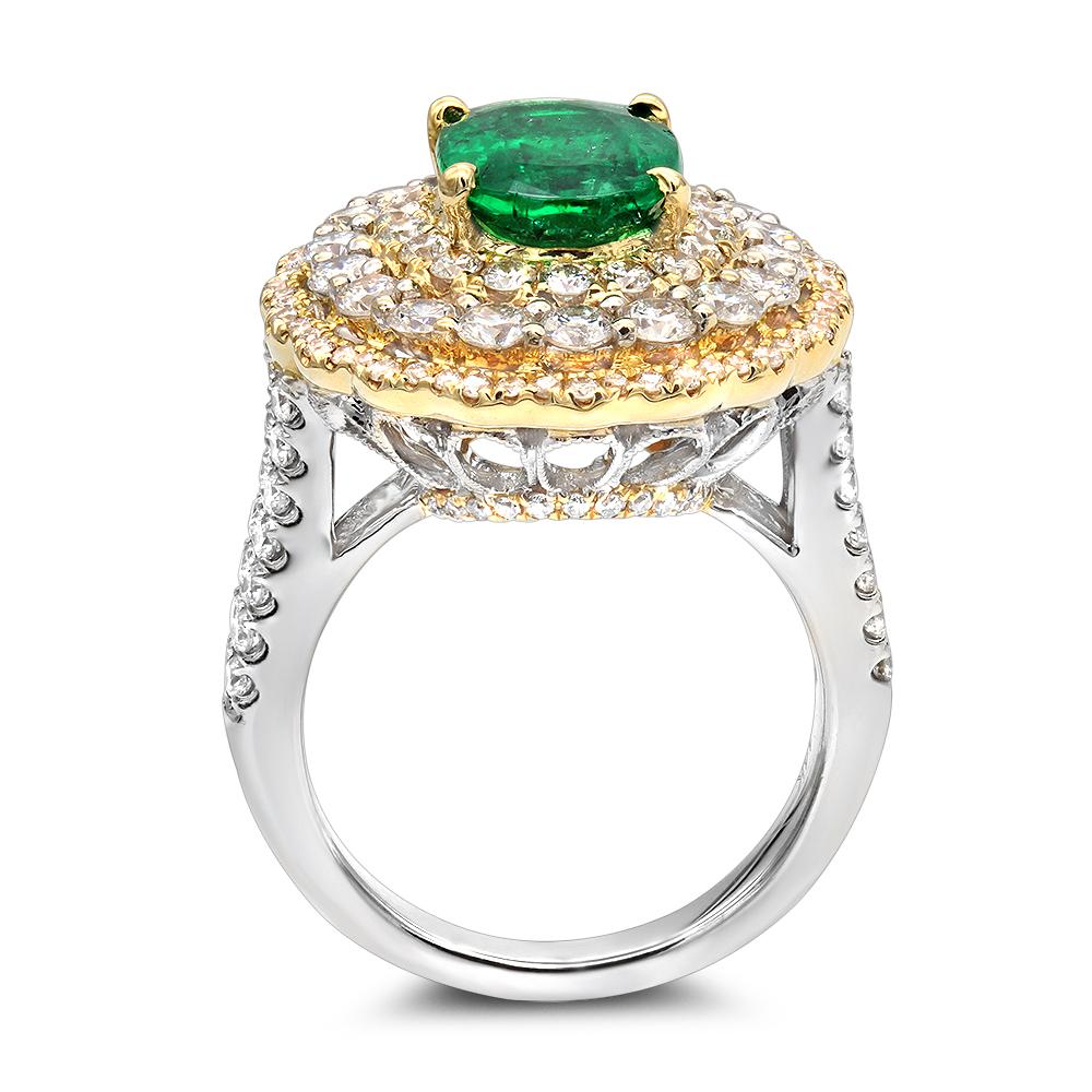 Ladies beautiful emerald and diamond ring Cocktail Ring.
Center stone contains a vibrant  2.29 carat Natural Oval Cut Emerald
Surrounded by  a triple halo of diamonds with a TW of 2.09 carat round cut brilliant diamonds.
14k white gold