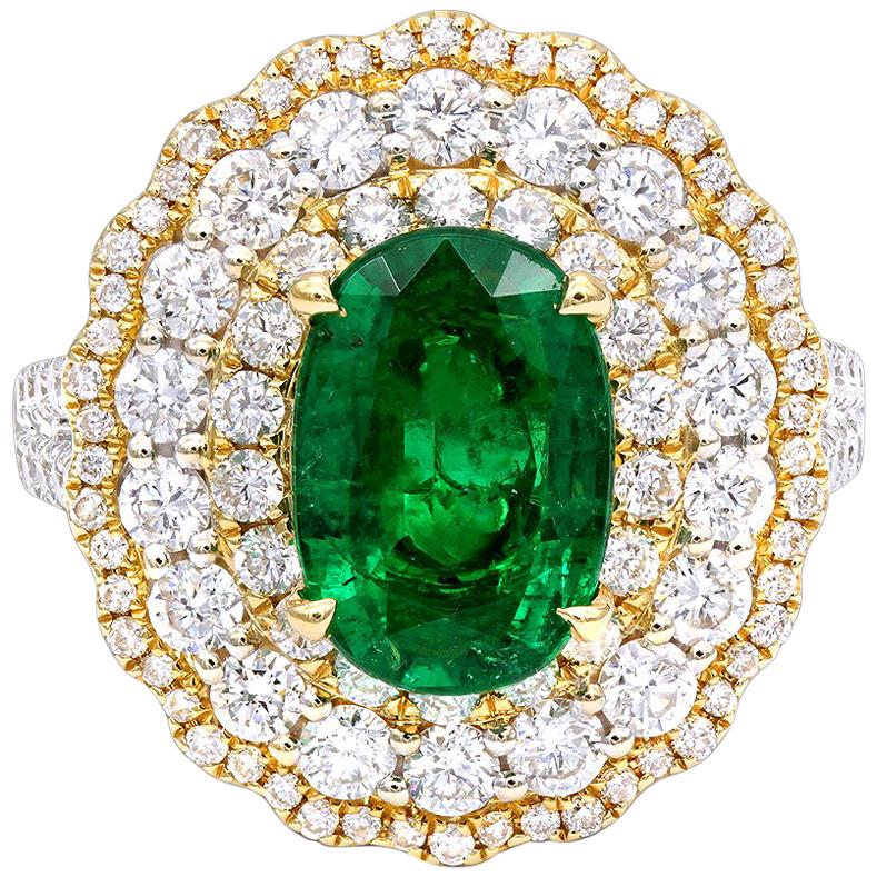 2.29 Carat Oval Cut Emerald & Diamond Triple Halo 14 Karat White Gold Ring For Sale