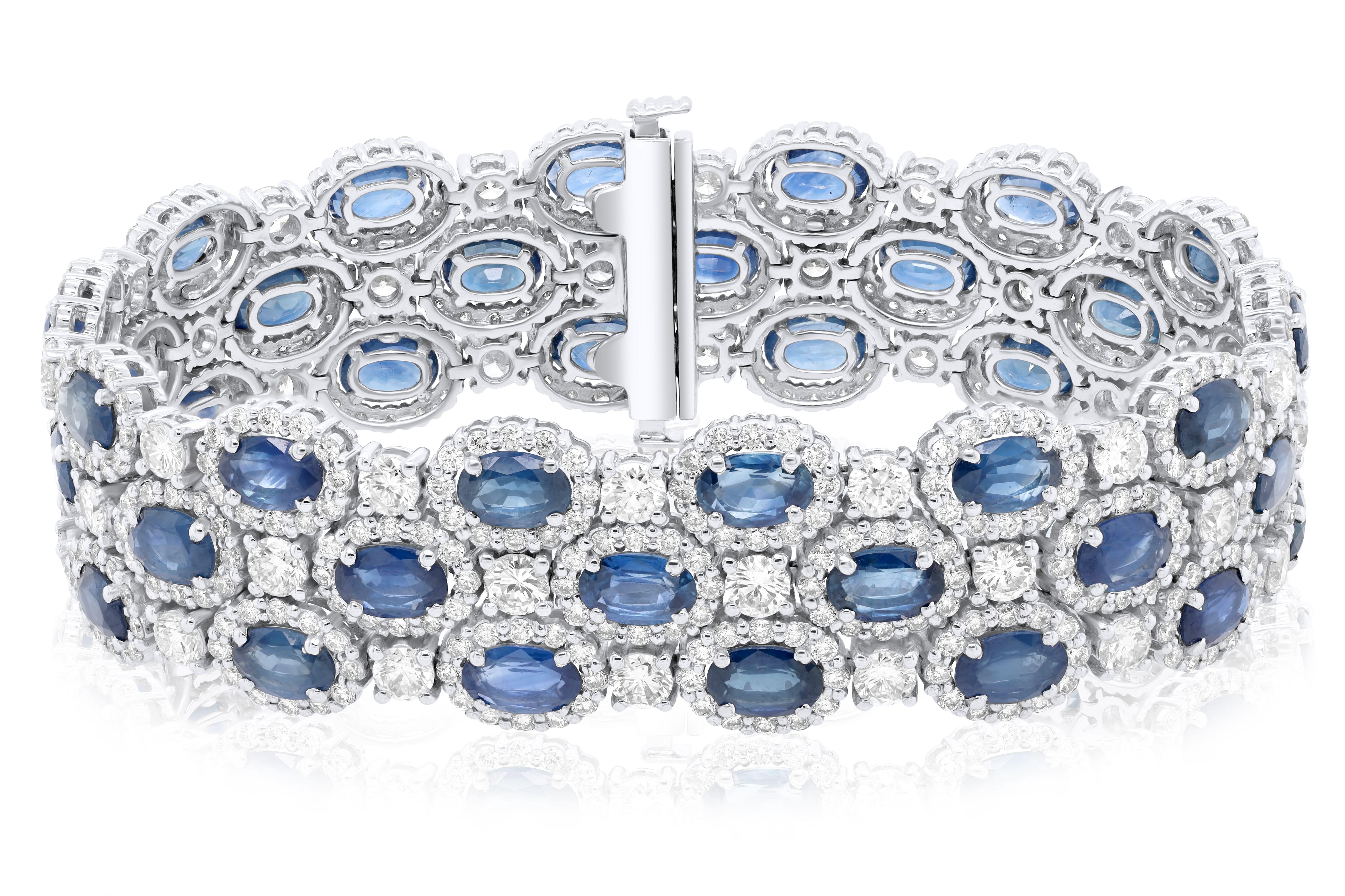 18 kt white gold bracelet adorned with 22.91 cts tw of oval cut sapphires surrounded and separated by 11.64 cts tw of diamonds packed hexagonally
