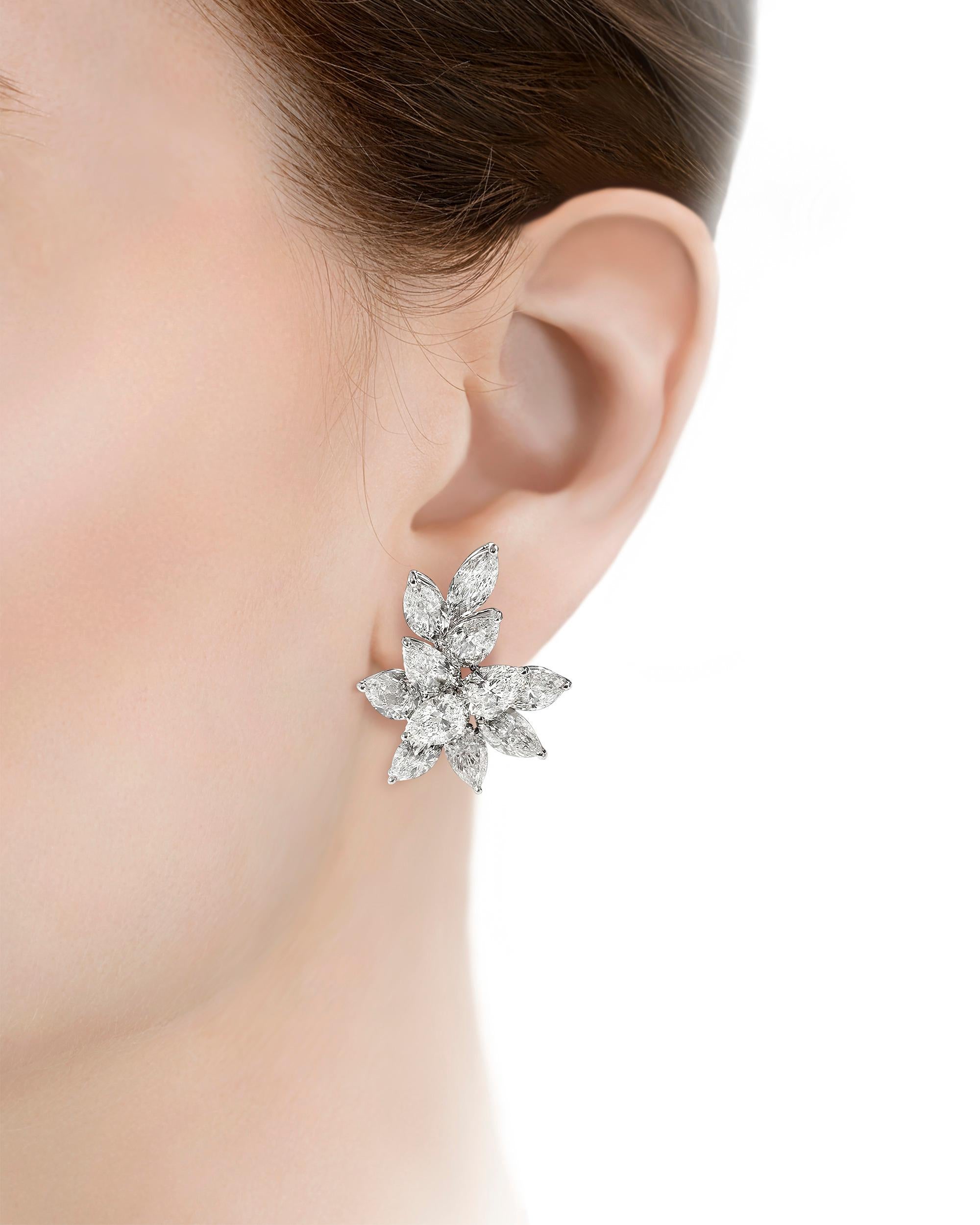 These magnificent diamond cluster earrings are a burst of luminosity. Weighing an impressive 22.99 carats, these 22 marquise and pear-cut stones are perfectly matched and have been certified by the GIA as having D through G color. Set in platinum,