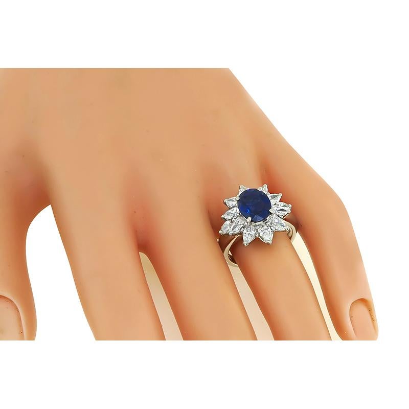 This is a stunning platinum engagement ring. the ring is centered with a lovely oval cut sapphire that weighs approximately 2.29ct.The sapphire is accentuated by sparkling marquise cut diamonds that weigh approximately 1.82ct. The color of these