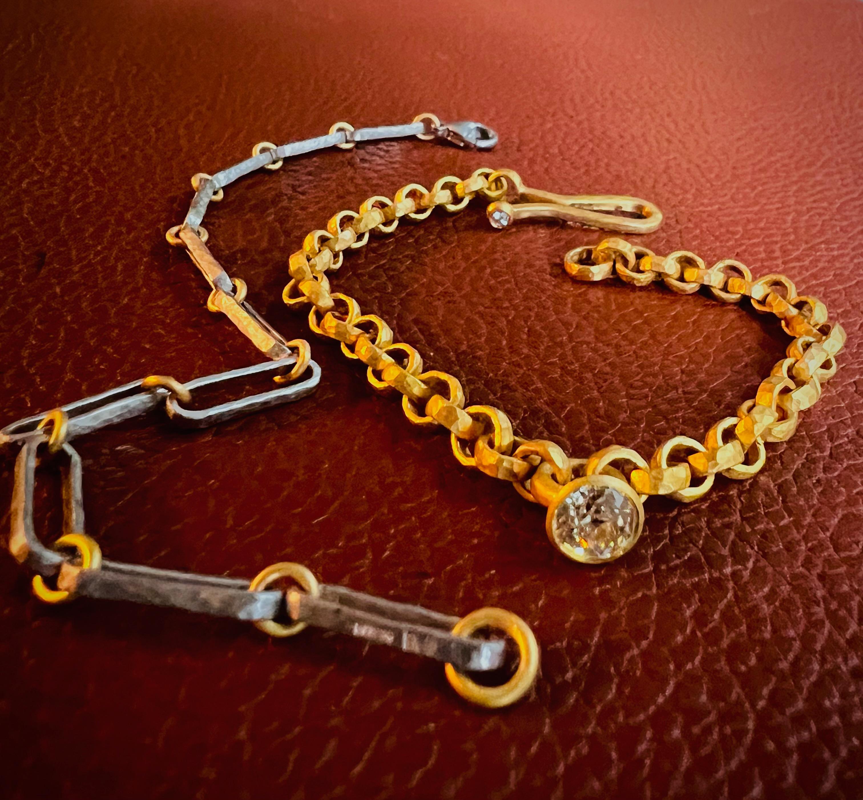 A 22ct gold hammered handmade link chain bracelet adorned with an antique old-cut round diamond set in 22ct gold. The combination of the craftsmanship of a handmade link chain bracelet, the richness of 22ct gold, and the allure of an antique old-cut