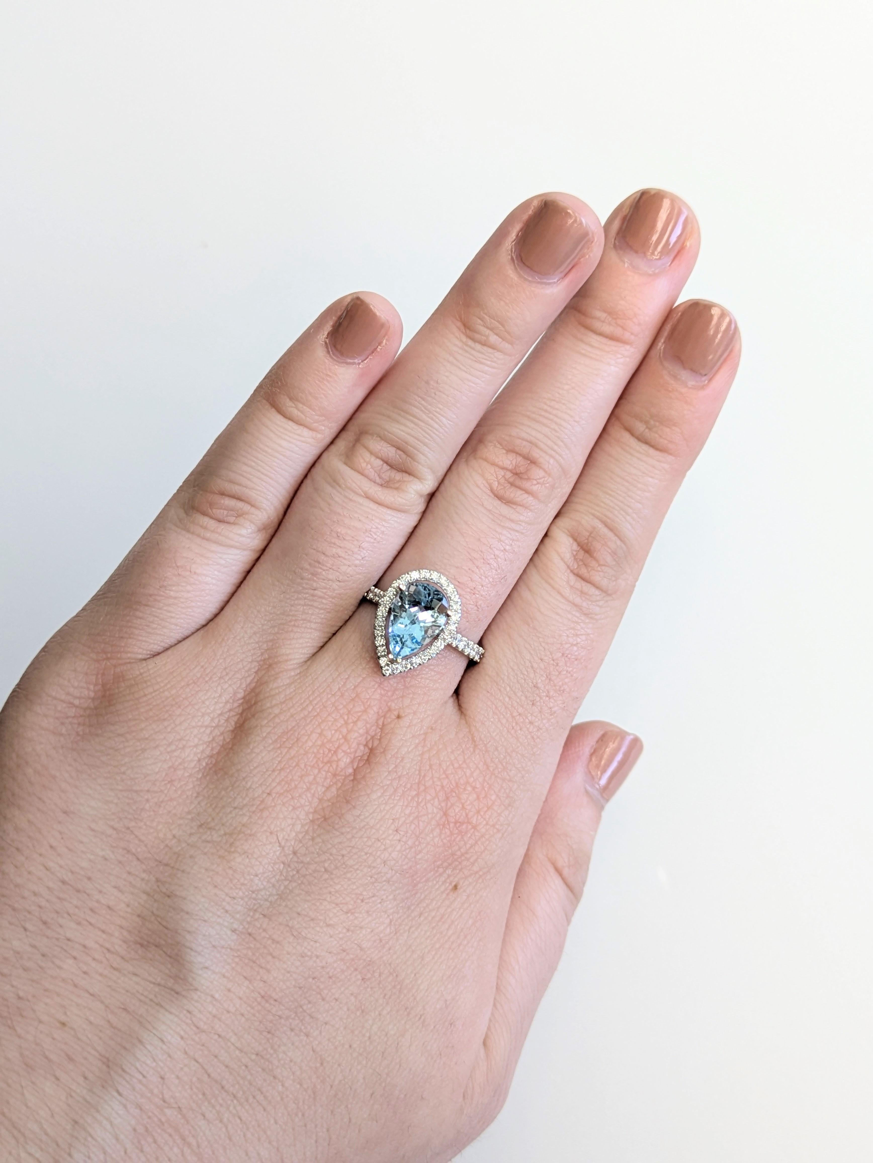 This 2.18 carat Santa Maria aquamarine glows in a pear shape, framed by a halo of earth-mined diamonds and a pavé diamond shank. Set in solid 14k real gold, it’s a stunning statement of refined elegance.

**We offer complimentary resizing, message
