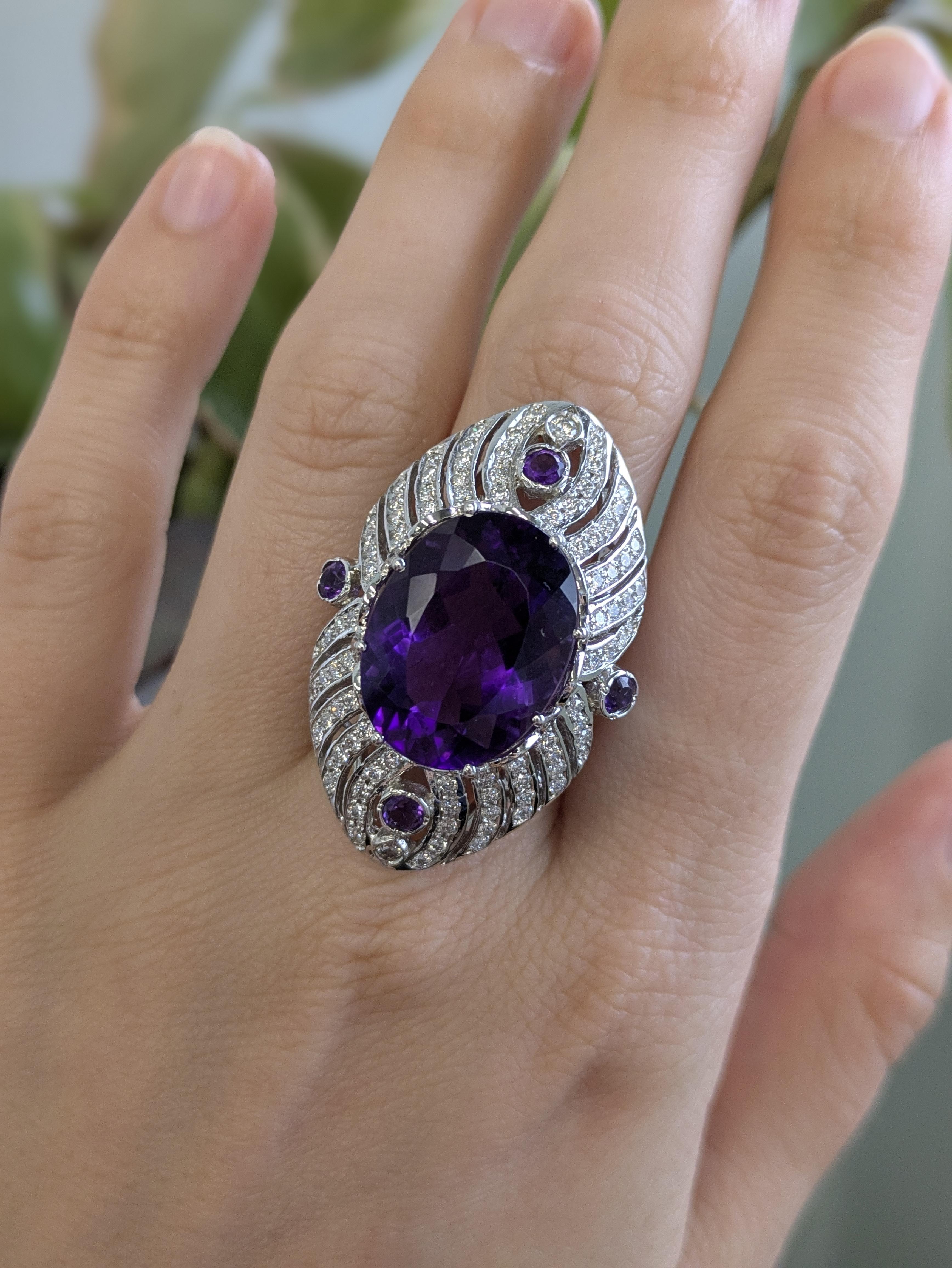 This striking ring features a large 20x15mm oval amethyst, set in solid 14K white gold and accented with natural, earth-mined diamonds. With its bold presence and classic elegance, it’s designed to turn heads at every occasion.

