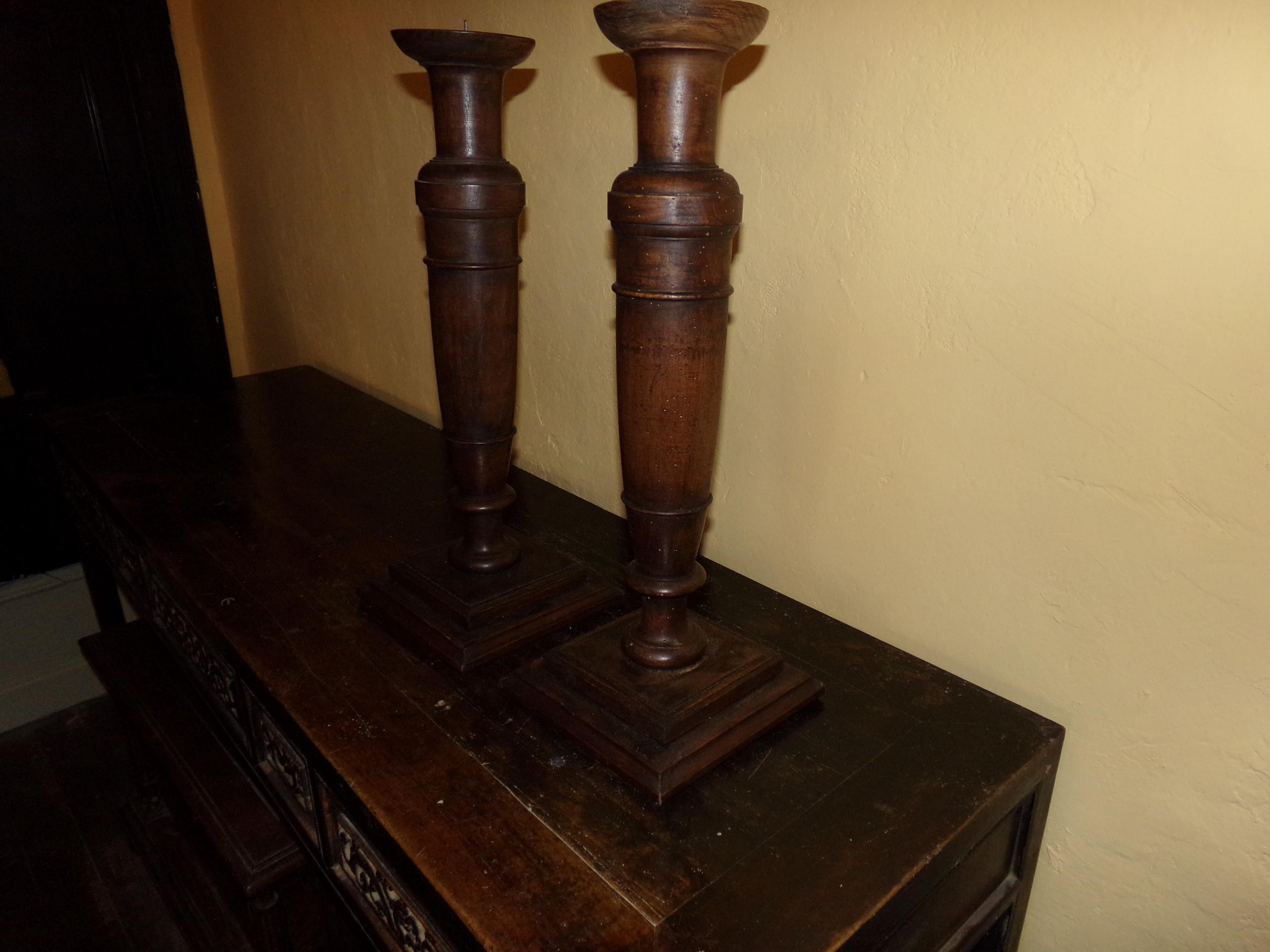A grand pair of turned and fluted hand carved pricket walnut torchiers or candlesticks beautifully crafted from original circa 1890s wood turnings. Our craftsman has retained all the original patination. A beautiful holiday gift for all the
