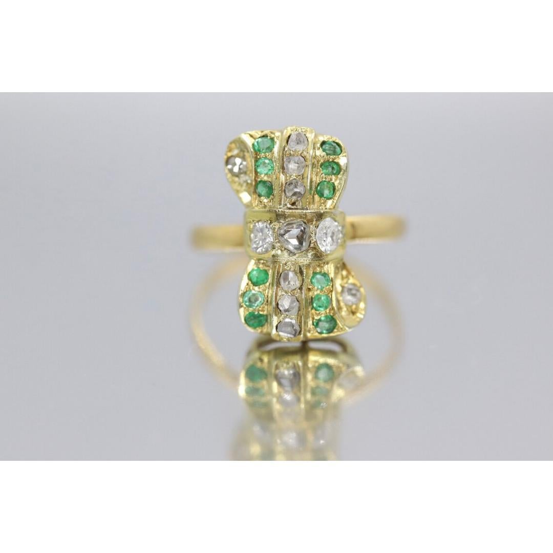 Vintage from the 1960s
Size: 5 US
Materials: Gold
Gemstone: Diamond
Gem color: Green

Band Color: Gold

Beautiful rough cut Diamond and Emerald BOW Tie ring. Band tests at 22k. The top Bow setting tests at 10K.

Details:
2.6grams total weight
2mm 3