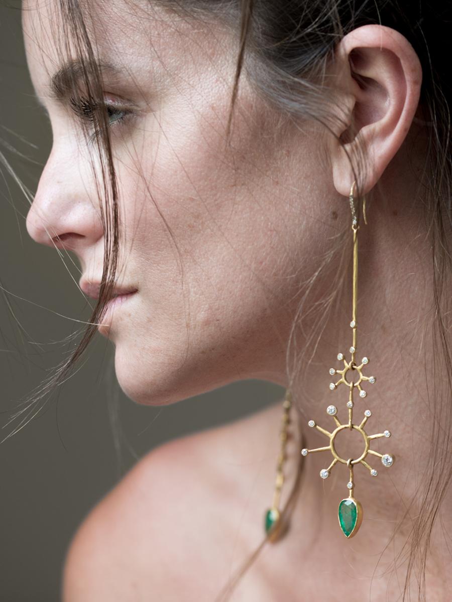 This one of a kind pair of asymmetric, 22k/18k gold earrings with Gemfields emeralds and brilliant cut diamonds are true show stoppers. This pair of shoulder dusters feature 8.37 carats of ethically sourced Zambian emeralds, bezel set and nearly one