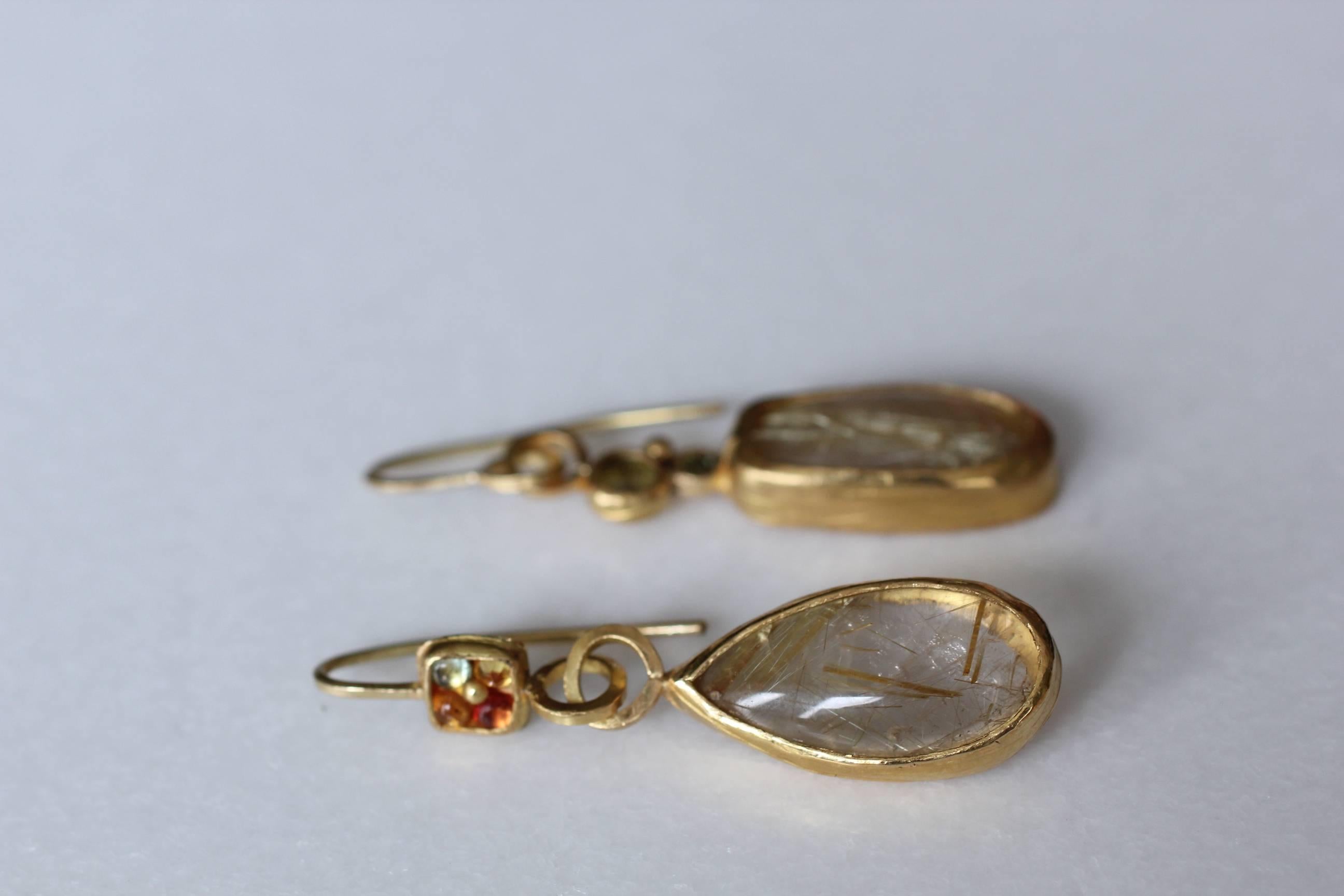 Circus Earrings. Fun, asymmetrical handcrafted 21k solid gold dangle drop earrings featuring gold rutilated quartz highlighted with sapphires and tourmalines. Perfect for every day. Their neutral subtle color allows easy coordination with just about
