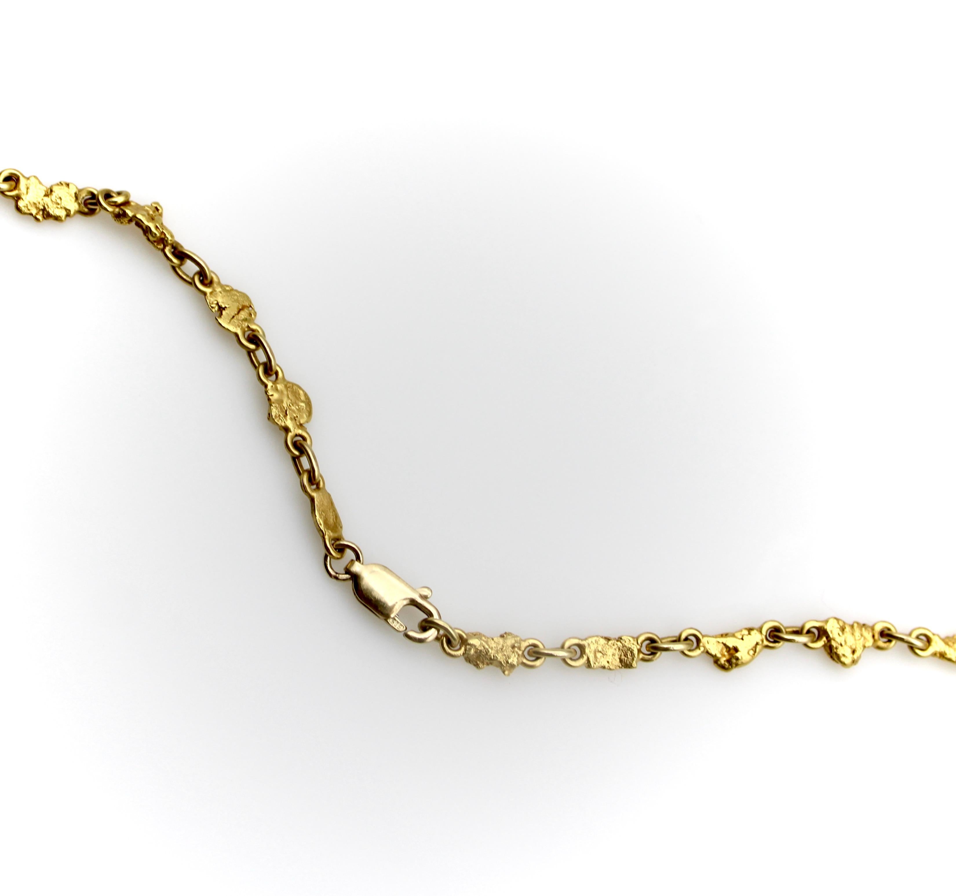 The gold nuggets in this necklace are impeccably well-matched, each one hand-selected for its shape. Every nugget in the piece is flat on the top edge and organically curved on the bottom so that the nuggets create a clean line within the chain. The