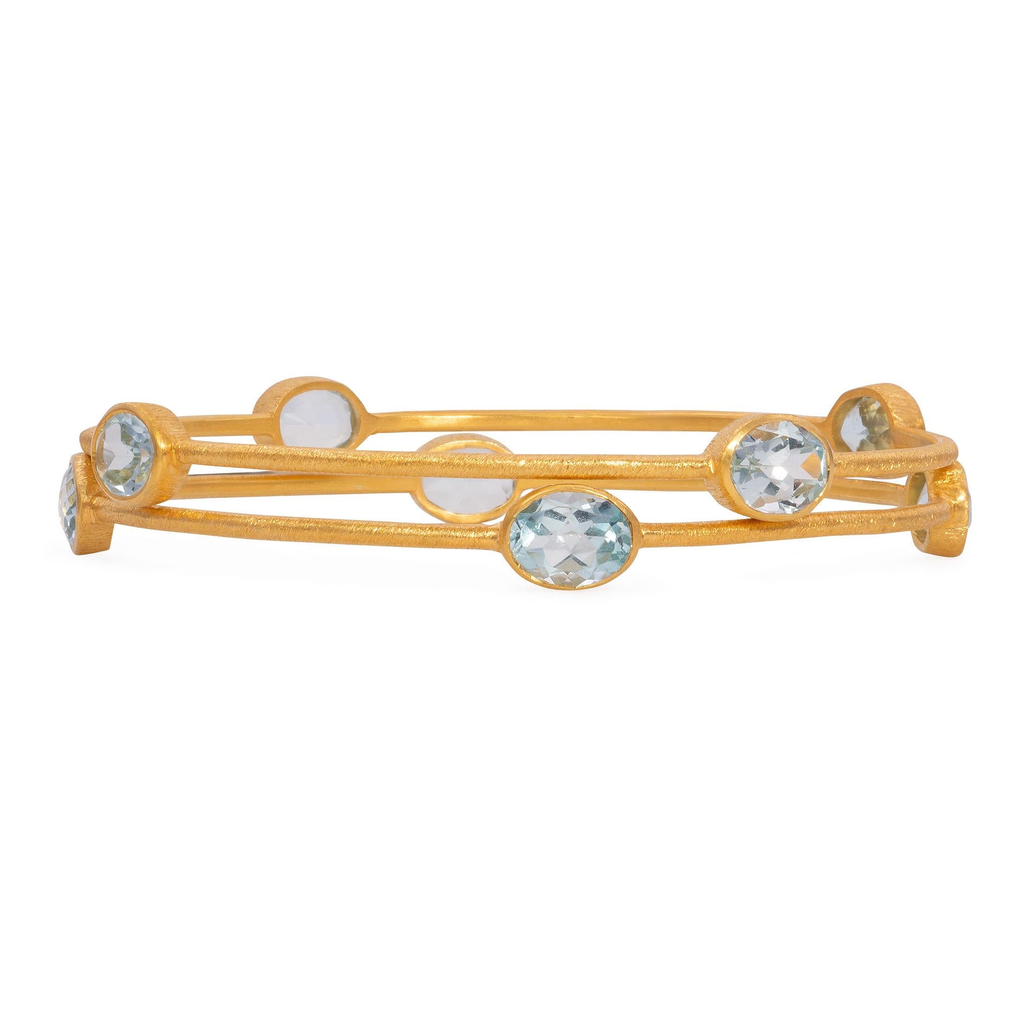 22k Brushed Gold Vermeil Bangle with 4 London Blue Topaz Stones.  London Blue Topaz is topaz stone that has a specific medium blue color. It’s darker then aquamarine or Swiss Blue Topaz, but lighter than what we normally look for in a blue sapphire.