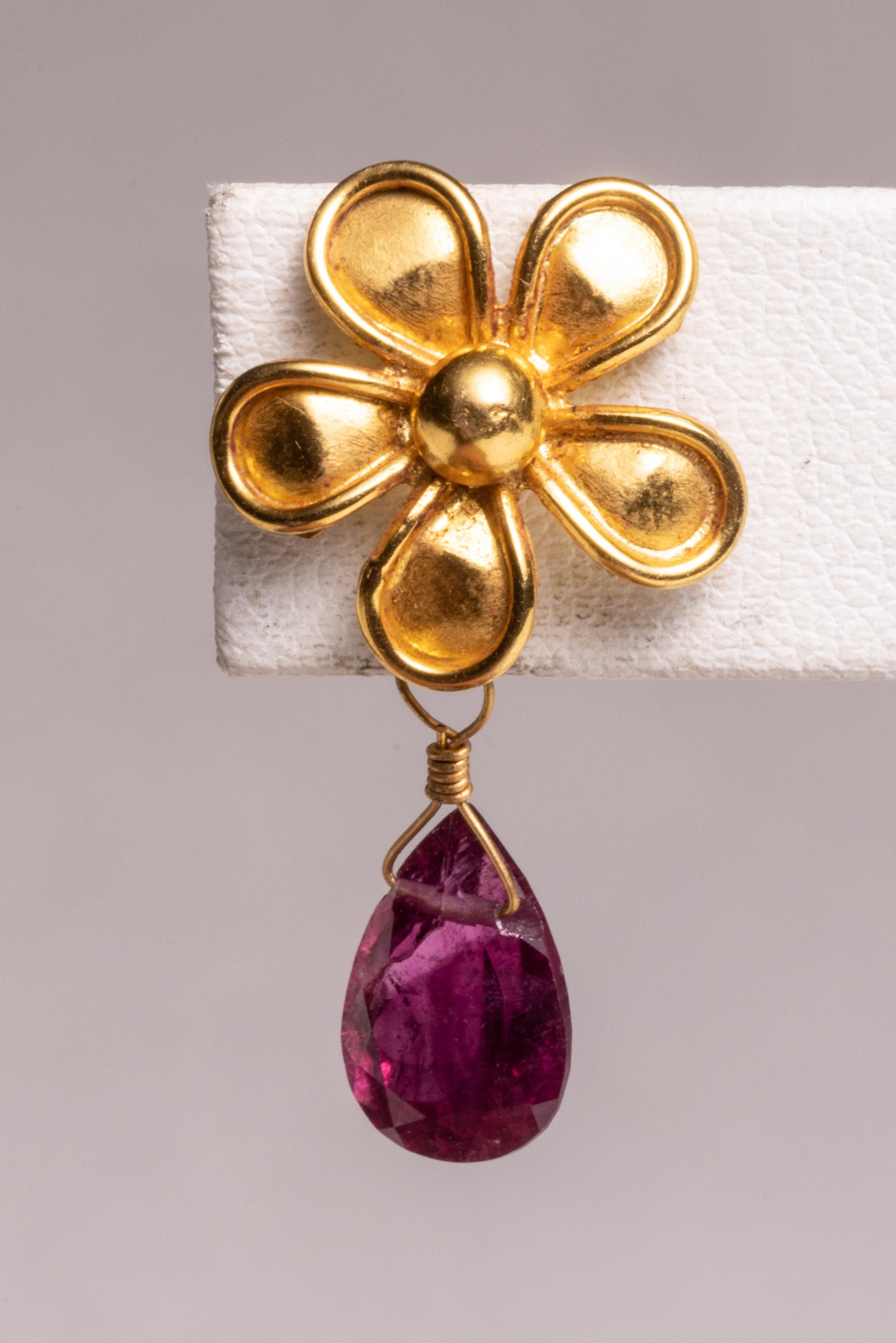 A lovely 22K gold flower post earring with a pear-shaped, faceted pink tourmaline briolette drop.  For pierced ears.

The fine jewelry collection is sourced, designed or created by Deborah Lockhart Phillips. Through her international travels, she