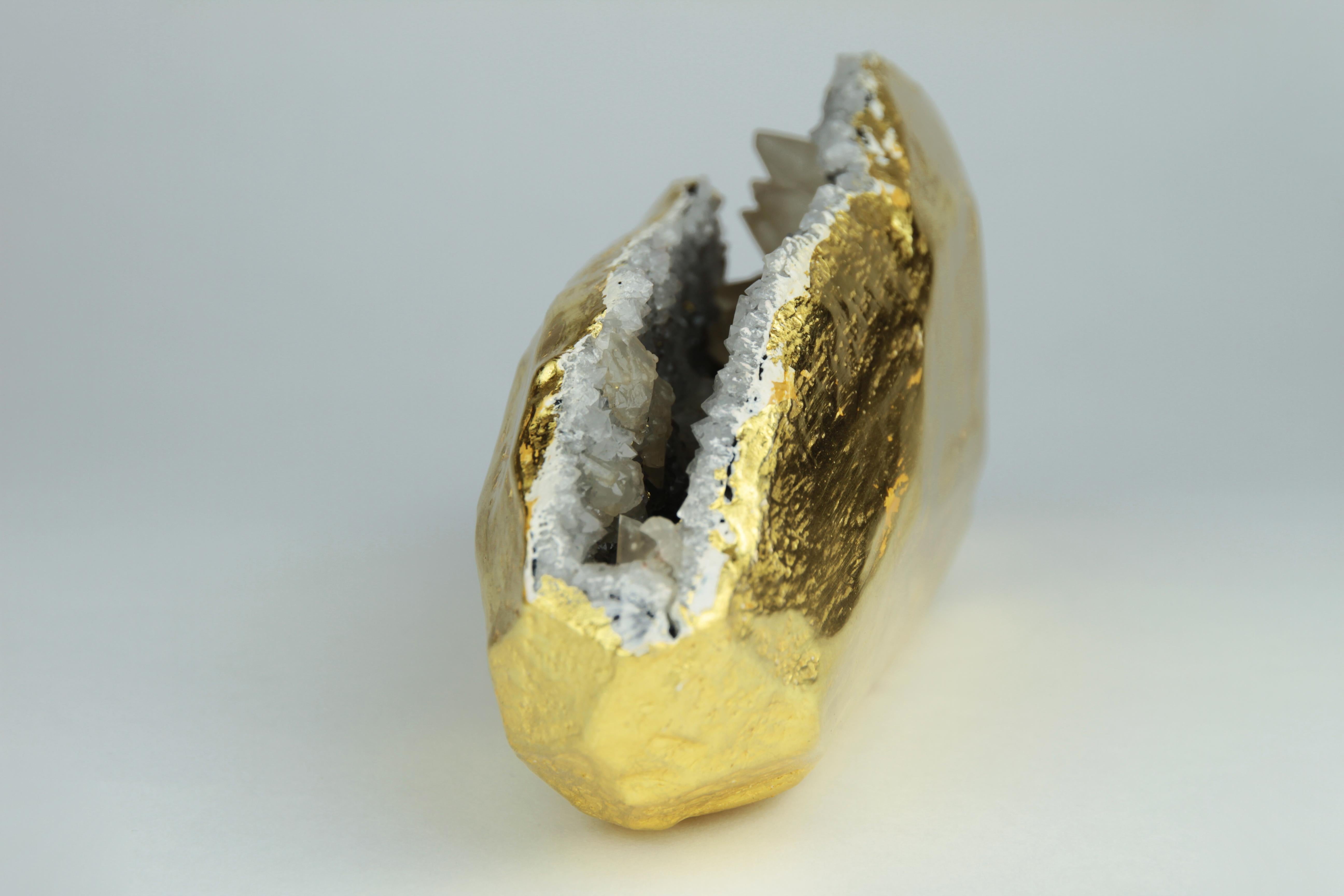 This unique crystal geode has been meticulously gilt in 22-karat gold leaf.
The one-of-a-kind natural sculpture will be a nice accent on a desk, coffee table, or anywhere it can be viewed from all sides.