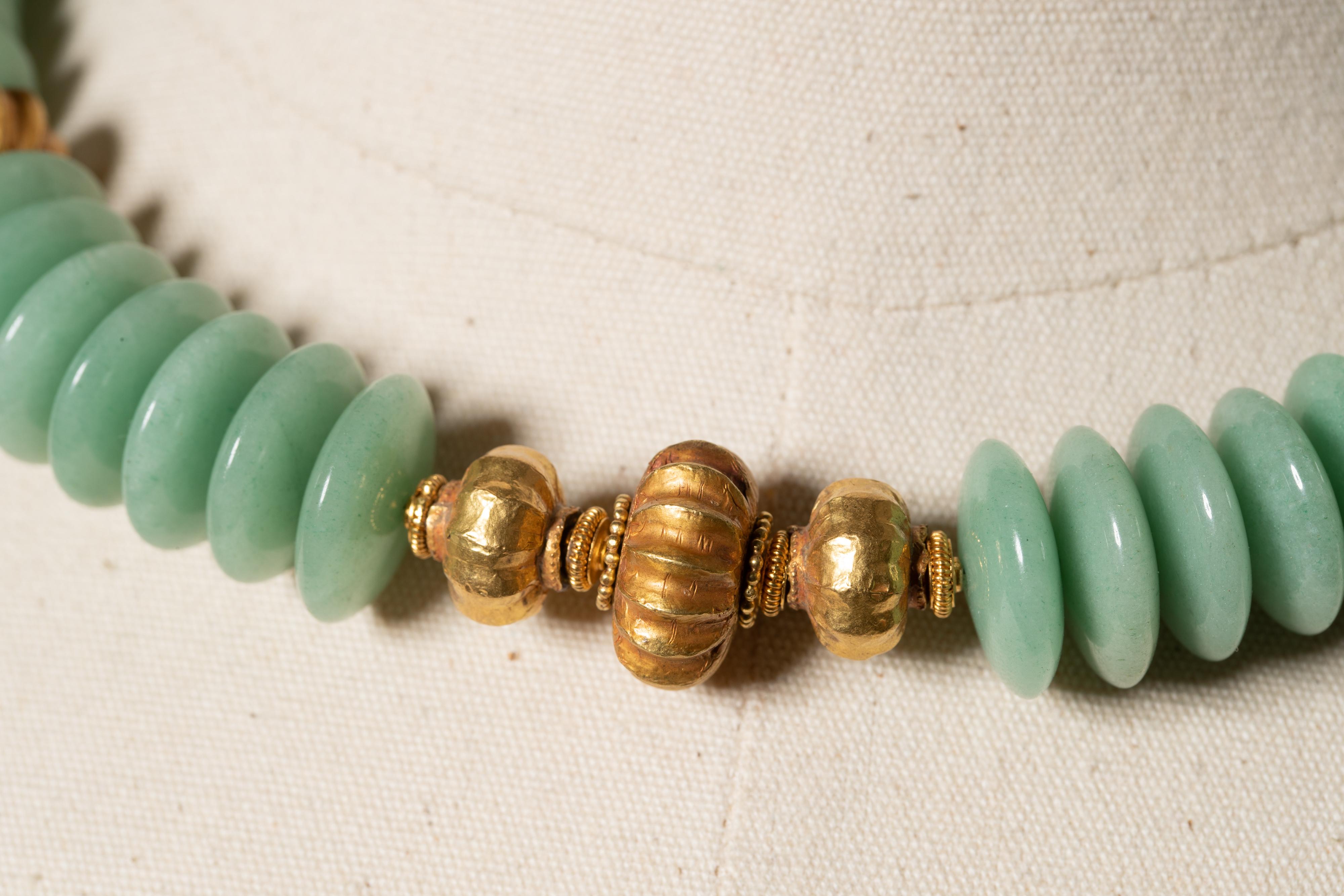 Large, unusual saucer adventurine beads with 22K gold beads at center and collarbone.  Prynite beads across the back and 22K gold S-hook clasp.