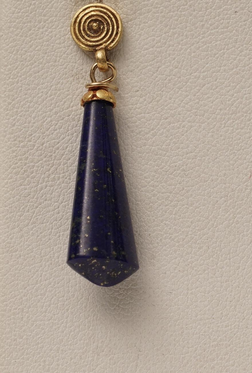 A pair of beautiful natural lapis lazuli drop earrings cut in an unusual shape in a beautiful peacock blue.  22K gold French wire for pierced ears.