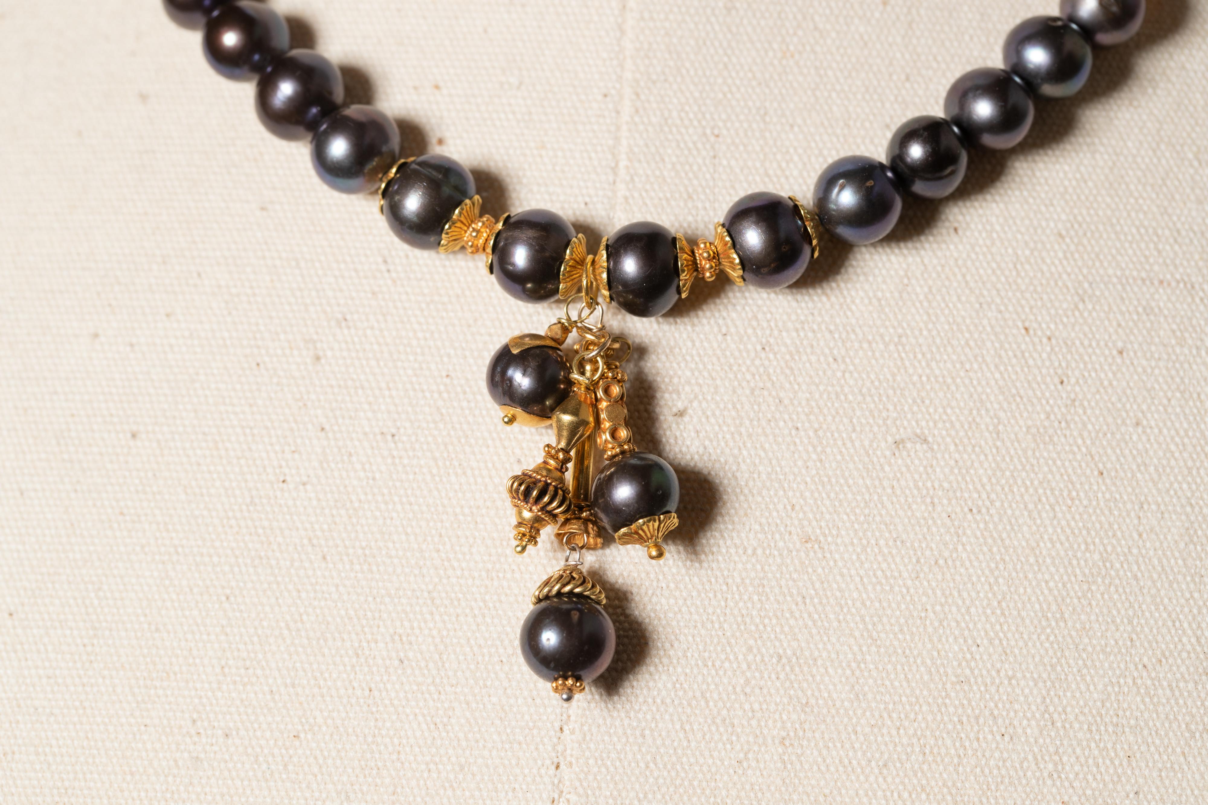 Round 9mm Tahitian pearls with 22K gold and a cluster of pearls and gold drops at the center, by Deborah Lockhart Phillips.  Pearl clasp at the back.  Just the drop portion of the necklace measures 1.5