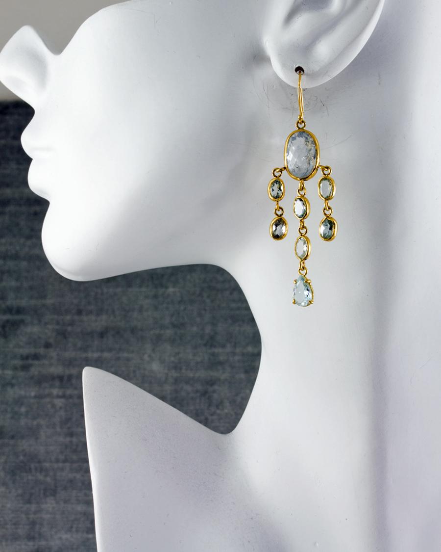 Palest, French blue aquamarine cascade in this pair of lovely chandelier earrings.  Completely handcrafted of 22k matte gold, most stones bezel set and the bottom tear drop set in prongs. A very comfortable pair with lots of movement reminiscent of