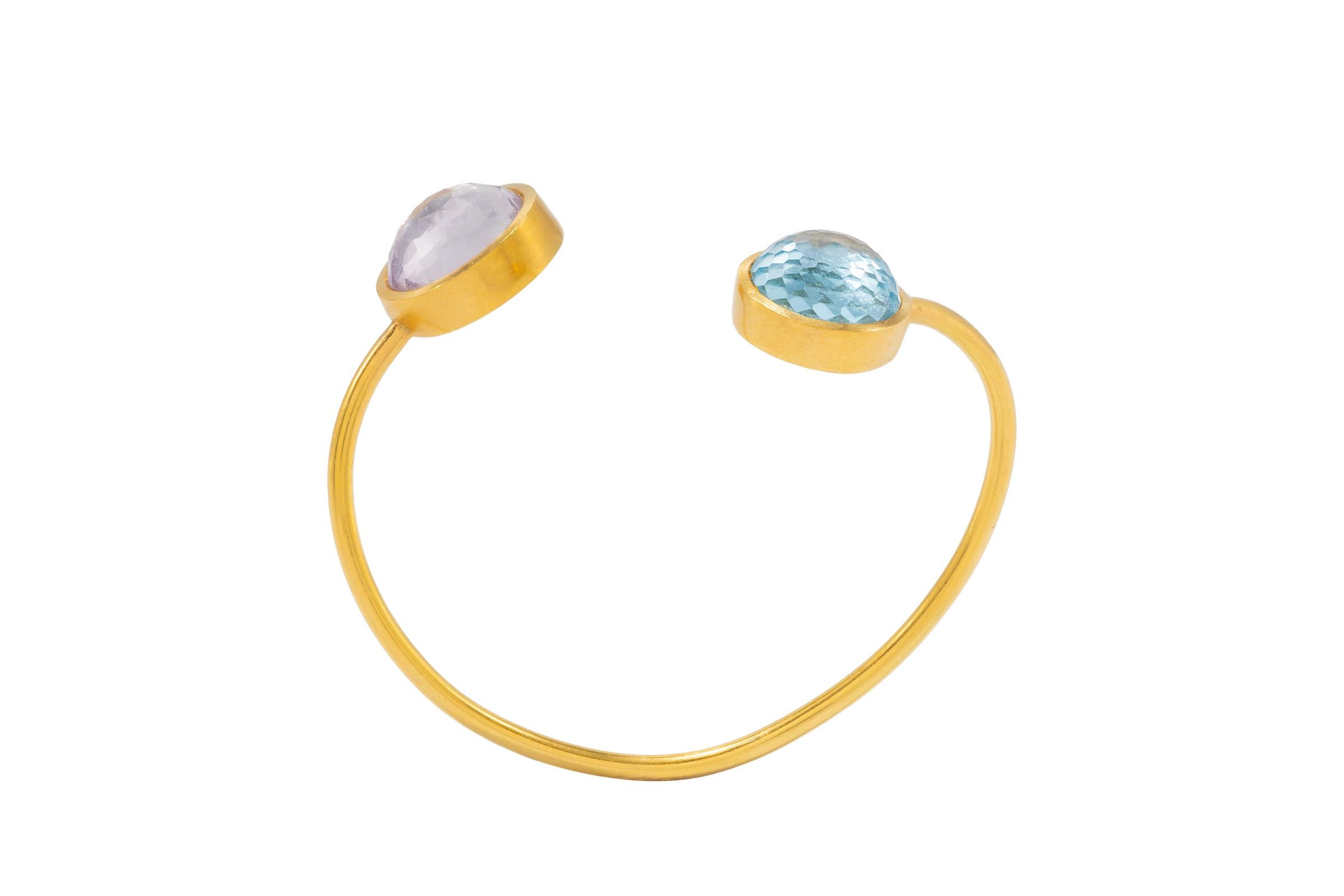 Part of our “Arm Candy” Collection, this gorgeous 22k gold bangle bracelet with Blue Topaz and Rose de France stones.  Looks beautiful with other bangle bracelets from this collection.
