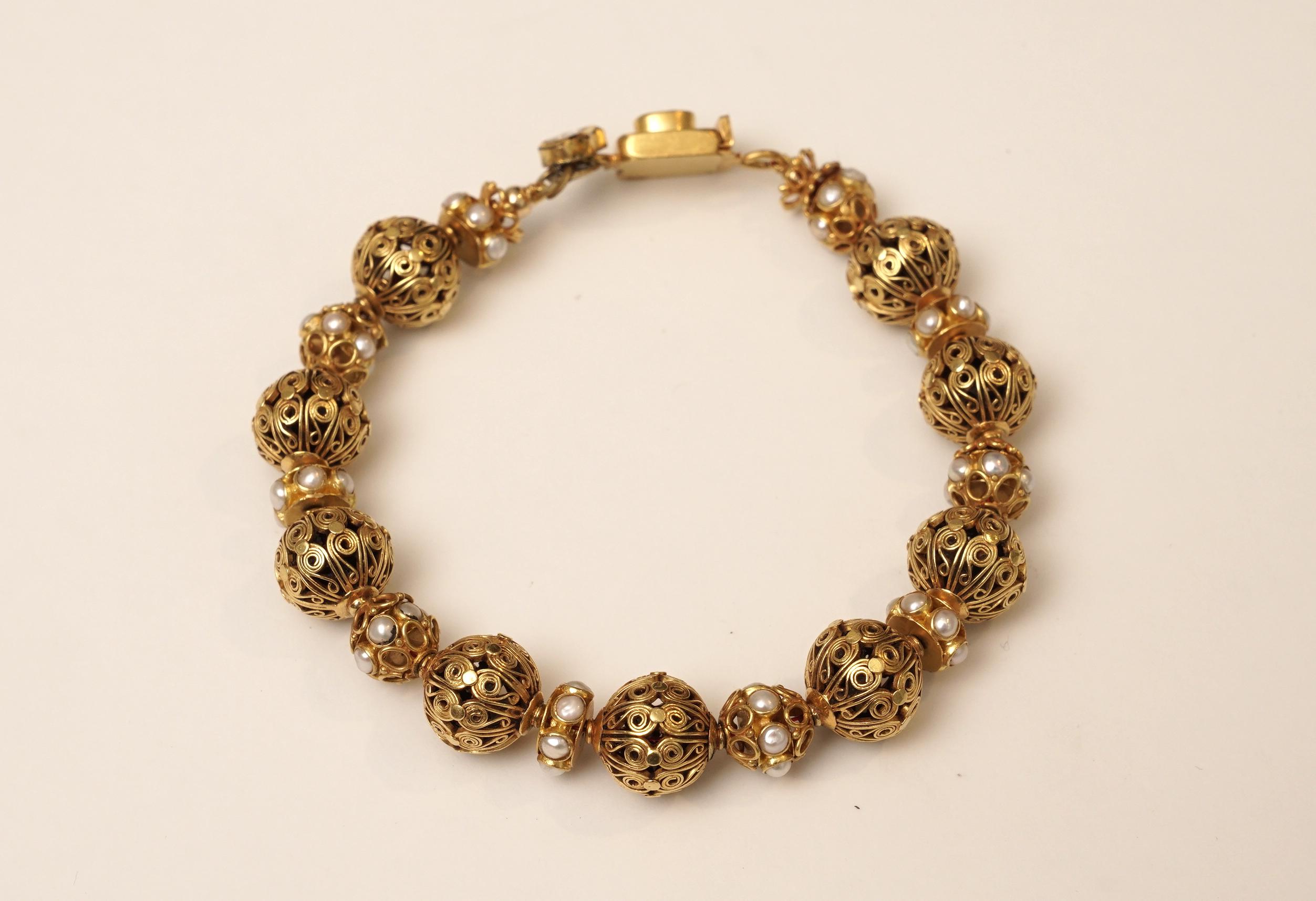 22k gold bead bracelet with intricate and beautiful wire work and pearl and gold rondelles in between.
 A sapphire push clasp with rose cut diamonds.  8.5 inches long.