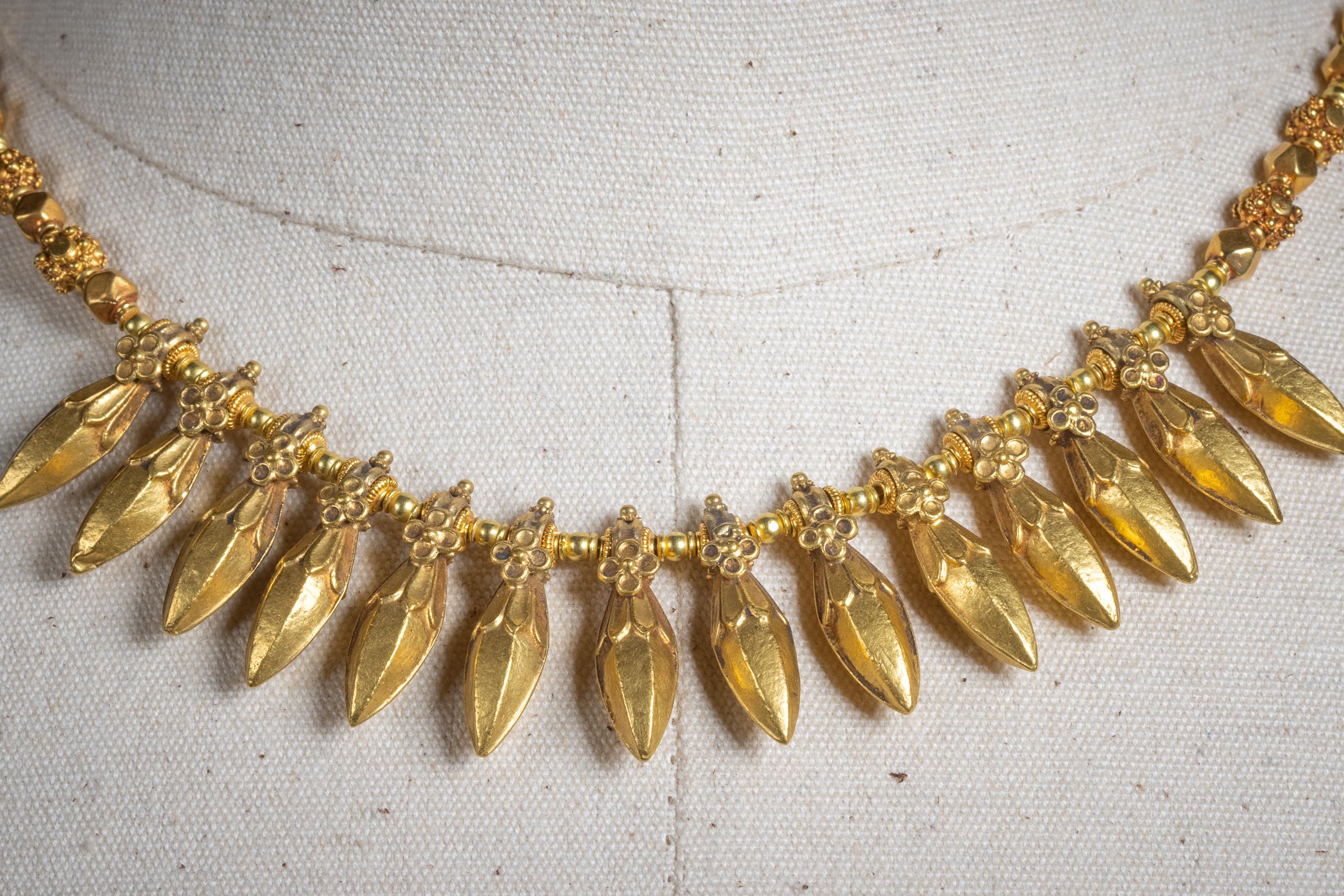 A stunning 22K gold Indian beaded necklace with dramatic gold pendant spears made using the lost wax technique.  The gold beads and pendants all have beautiful hand-tooled and granulation workmanship. S-hook clasp. Dates to the mid 1900's. 