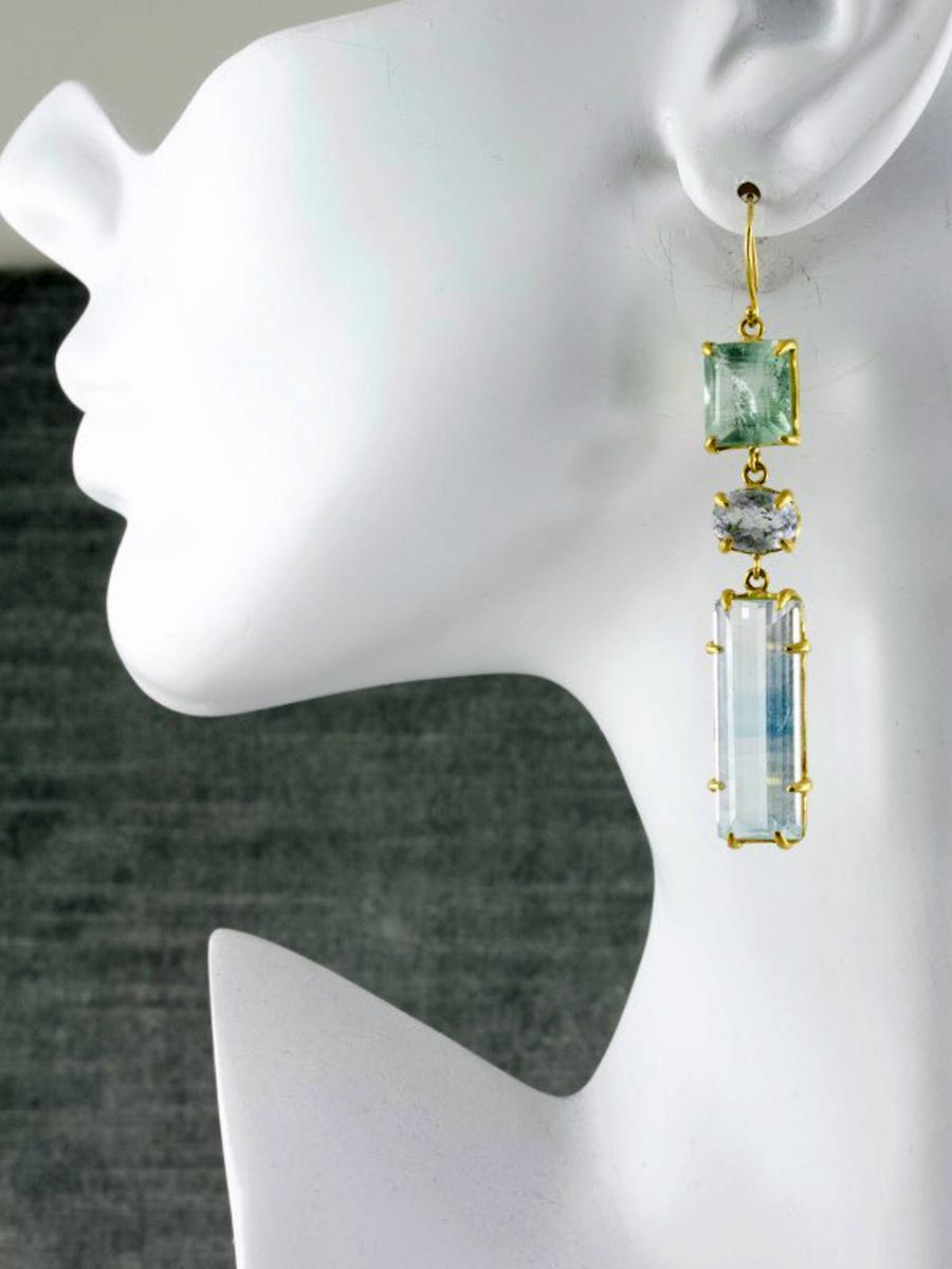 Watery hues are the hallmark of this one of a kind, asymmetric pair of earrings. Unusual and rare, bi-colored topaz and beautifully faceted aquamarine are prong set in matte 22k gold. Completely handcrafted earrings have ear wires for pierced