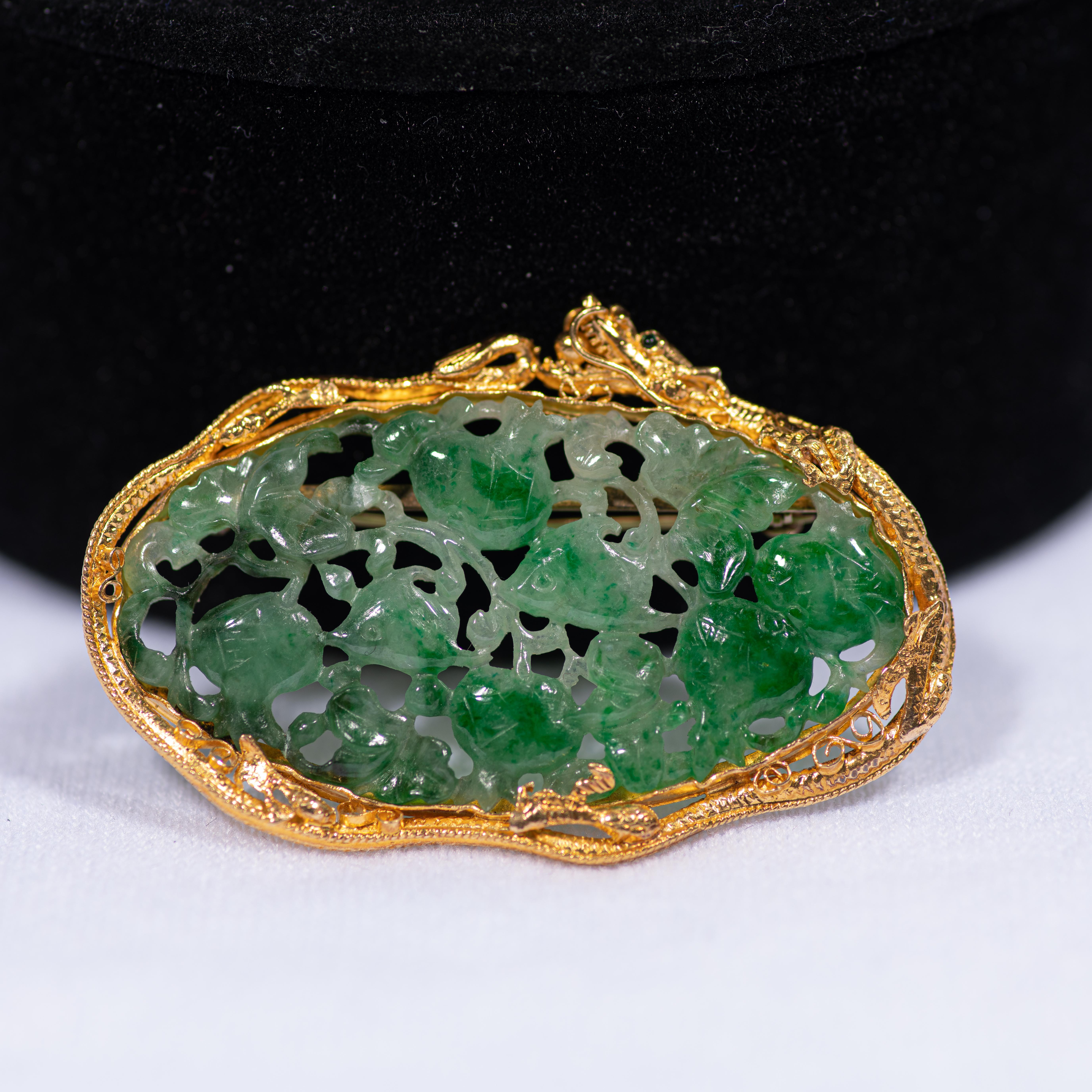 
A striking and gorgeous Chinese export brooch comprised of a luminous piece of carved and pierced jadeite in a 22k yellow gold setting shaped as a dragon with emerald eyes, China (probably Shanghai), circa 1930's. 

The jadeite of a mottled green