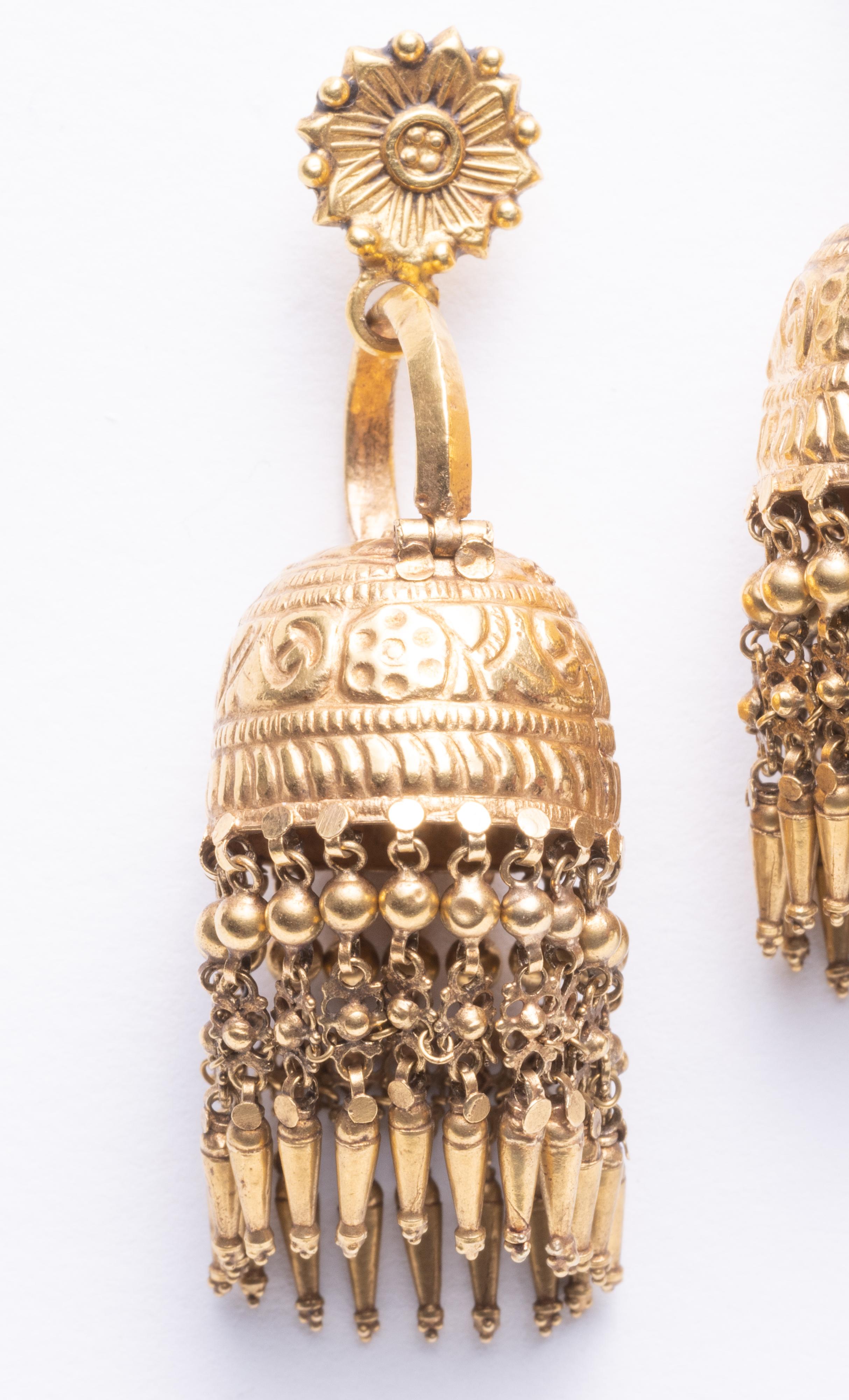 An intricately hand-tooled Indian chandelier earrings.  These normally would have been worn using the hinged curved bar, but for western use, we added the floral motif post for pierced ears.  Lovely movement with the dangling lower portion.