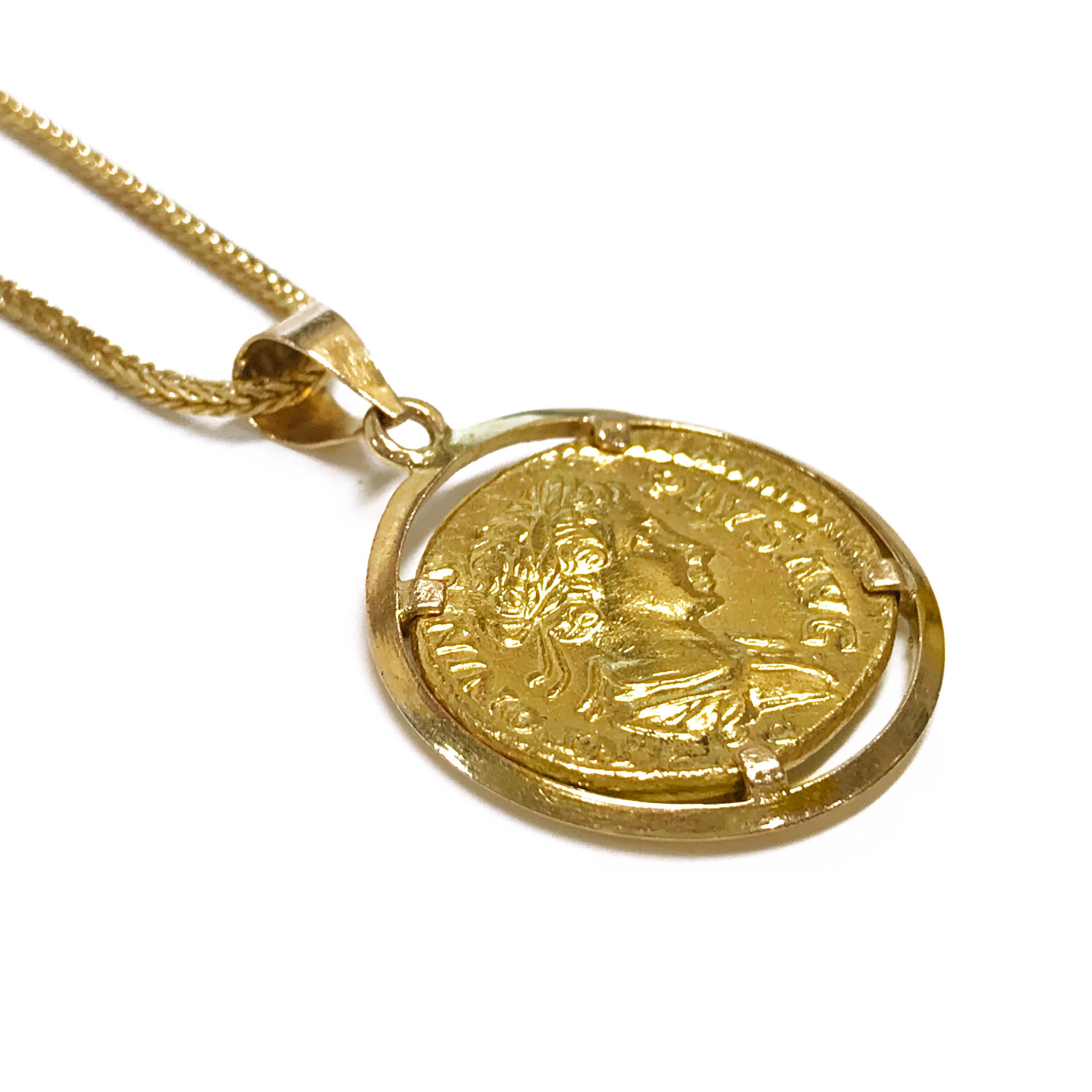 22 Karat Gold Coin Pendant with 18 Karat Bezel and 18 Karat Rope Necklace. The coin measures 0.66mm tall x 0.74mm wide x 0.08mm deep. The front of the coin depicts the image of a woman in profile with a ribbon in her hair. The back of the coin has