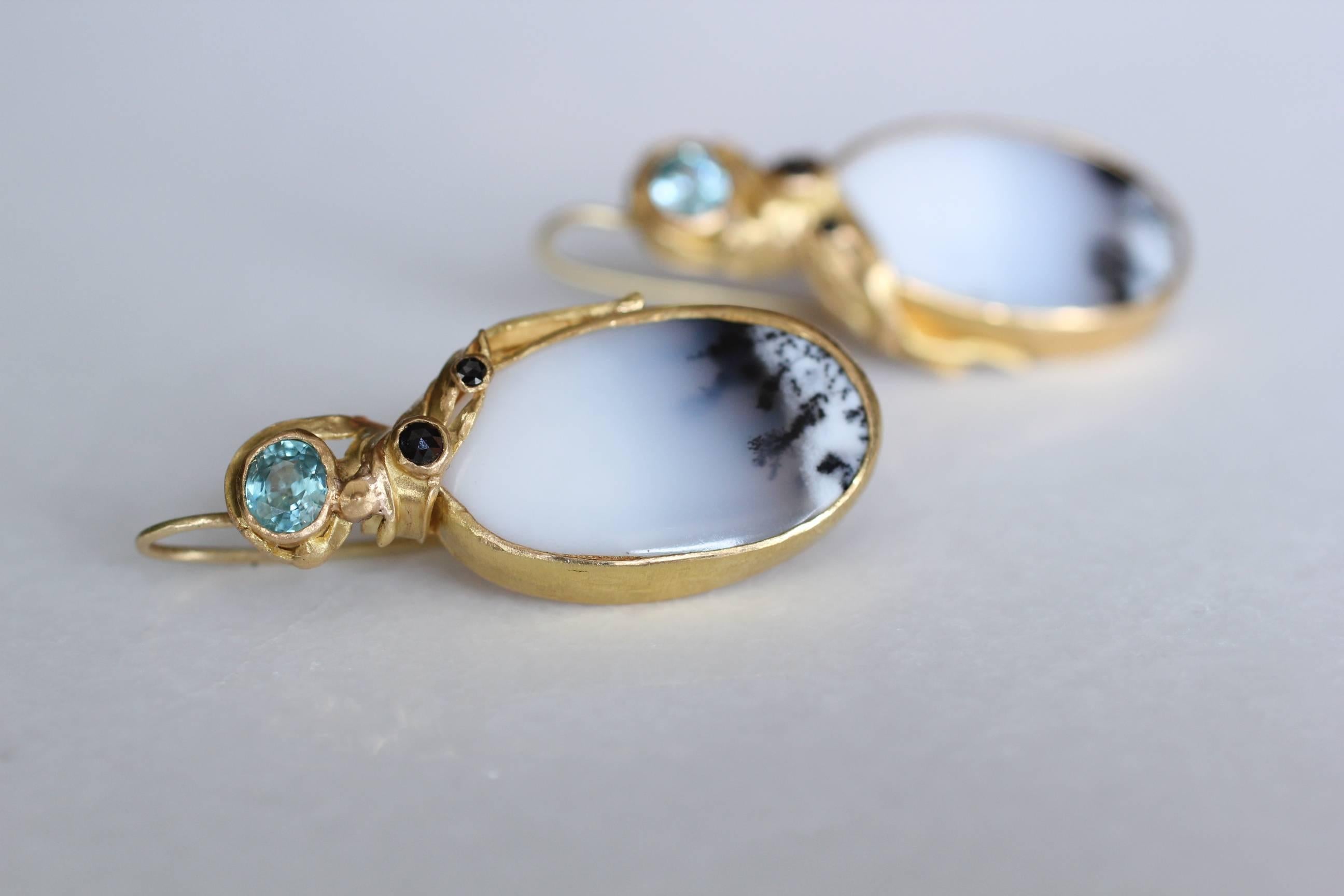 Antarctic Fog Earrings. Dendrite opals are like nature's time capsule, memorizing a moment in time millions of years ago. In these drop earrings, the opal is set in a beautiful organic 21K gold setting, emphasizing its crisp subtle colors, and