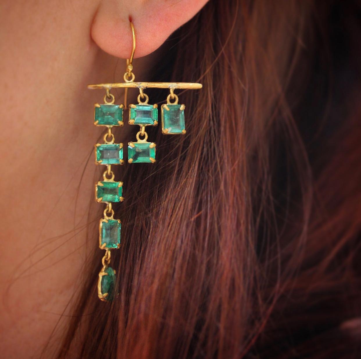 Nearly fifteen carats of ethically sourced, Gemfields, Zambian emeralds cascade gracefully from a hand hewn gold rod, perfectly balanced in a beautiful asymmetric earring.... an explosion of color. One of a kind with ear wires for pierced