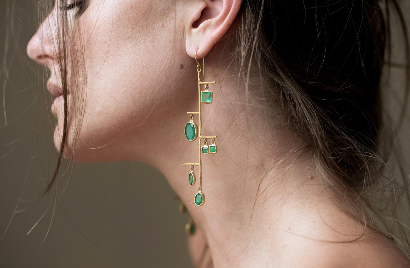One of a kind, completely hand crafted earrings with over 13 carats of ethically sourced Gemfields' Zambian emeralds.  This pair of artistically designed earrings takes inspiration from mid century modern aesthetic with a very modern approach.  This