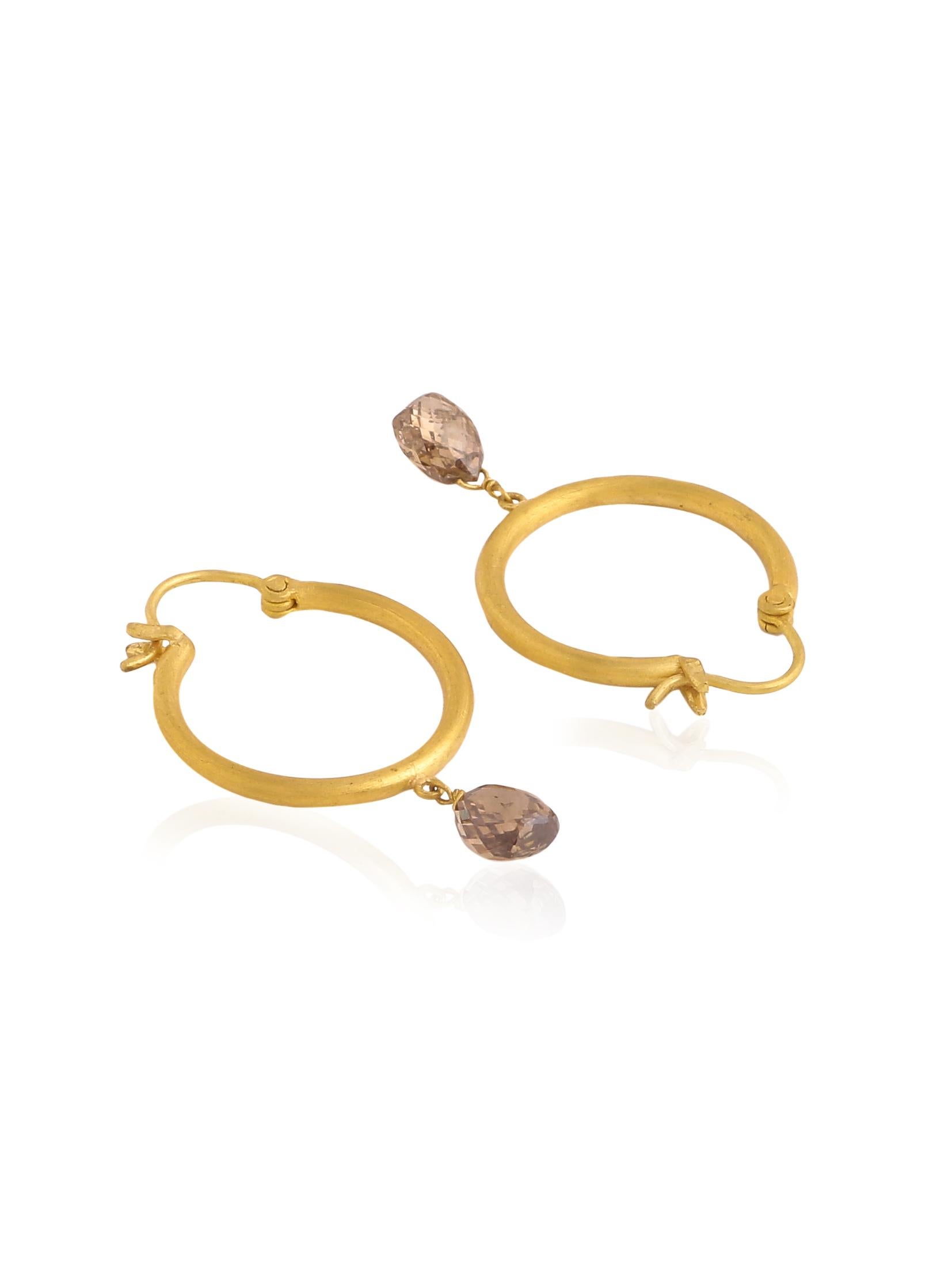 A pait of simple and elegant hoops hancrafted in 22K Gold with a pair of diamond briolettes hanging from each of them.
The diamonds are 4.35 carats altogether and add just that touch of bling needed. A wardrobe staple, these hoops are the perfect