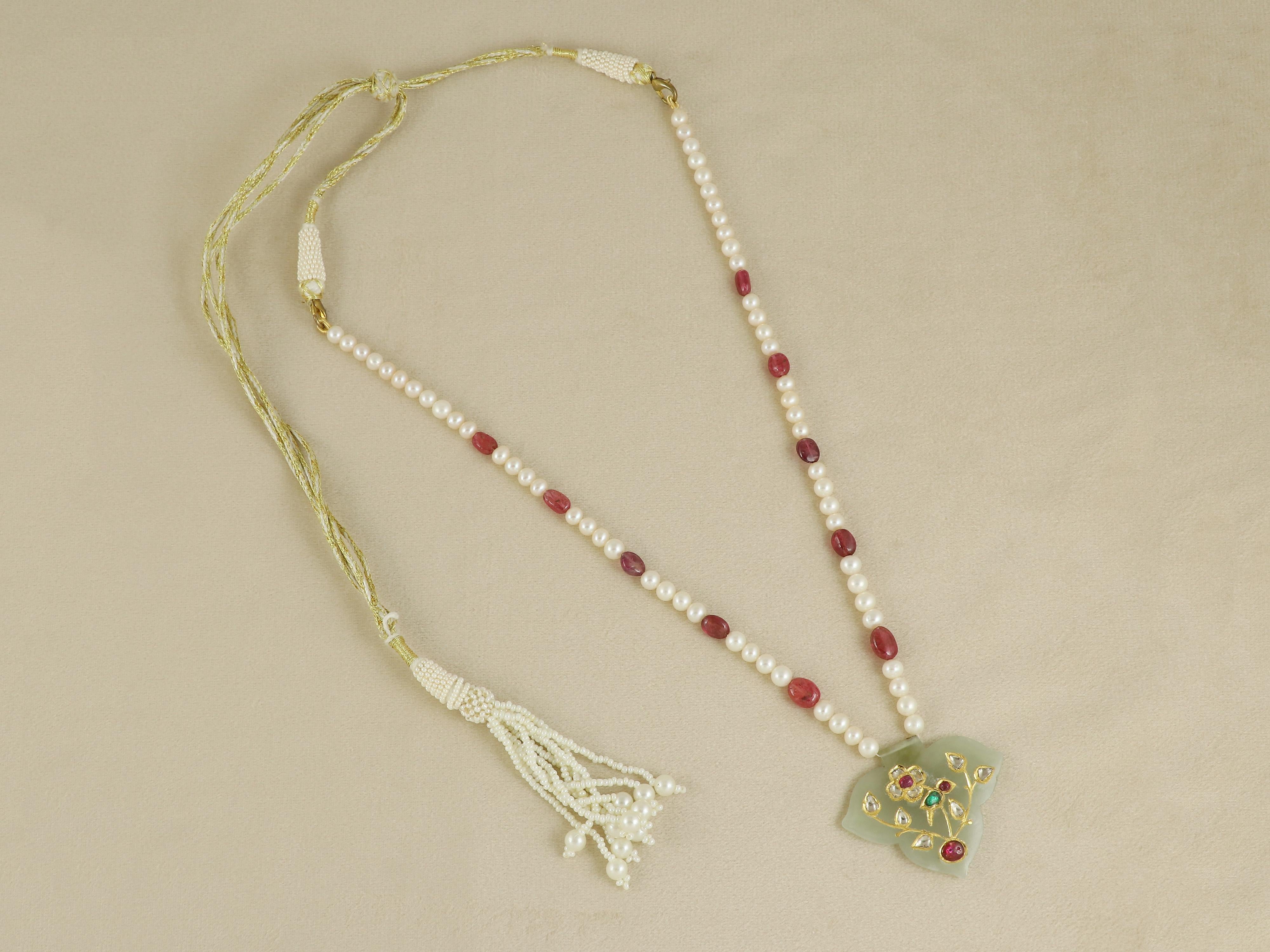 Un grazioso inno alla natura e all'artigianato, questo piccolo ciondolo è scolpito in pregiata giada nefrite e squisitamente intarsiato con un affascinante motivo di uccelli. Appollaiato delicatamente su un ramo, l'uccello prende vita grazie al