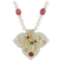 22K Gold Jadau jade pendant inlaid with gold, polki and rubies with bird motif
