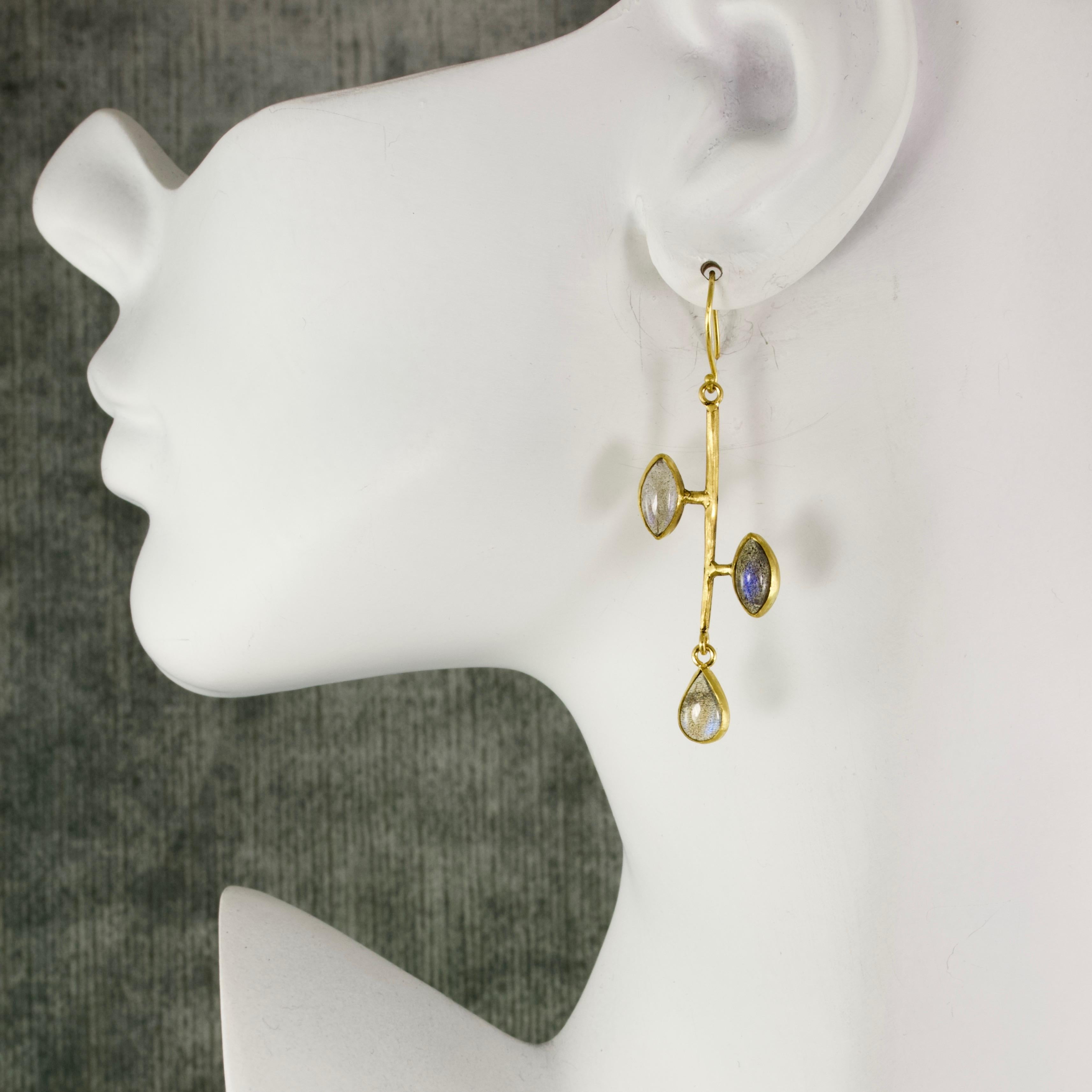Almond shaped, luminescent labradorite cabachons are set asymmetrically on these stick earrings, wrapped in matte 22k gold with a teardrop, bezel set labradorite hanging freely at the bottom.  This Bauhaus inspired pair is part of our Orpheus