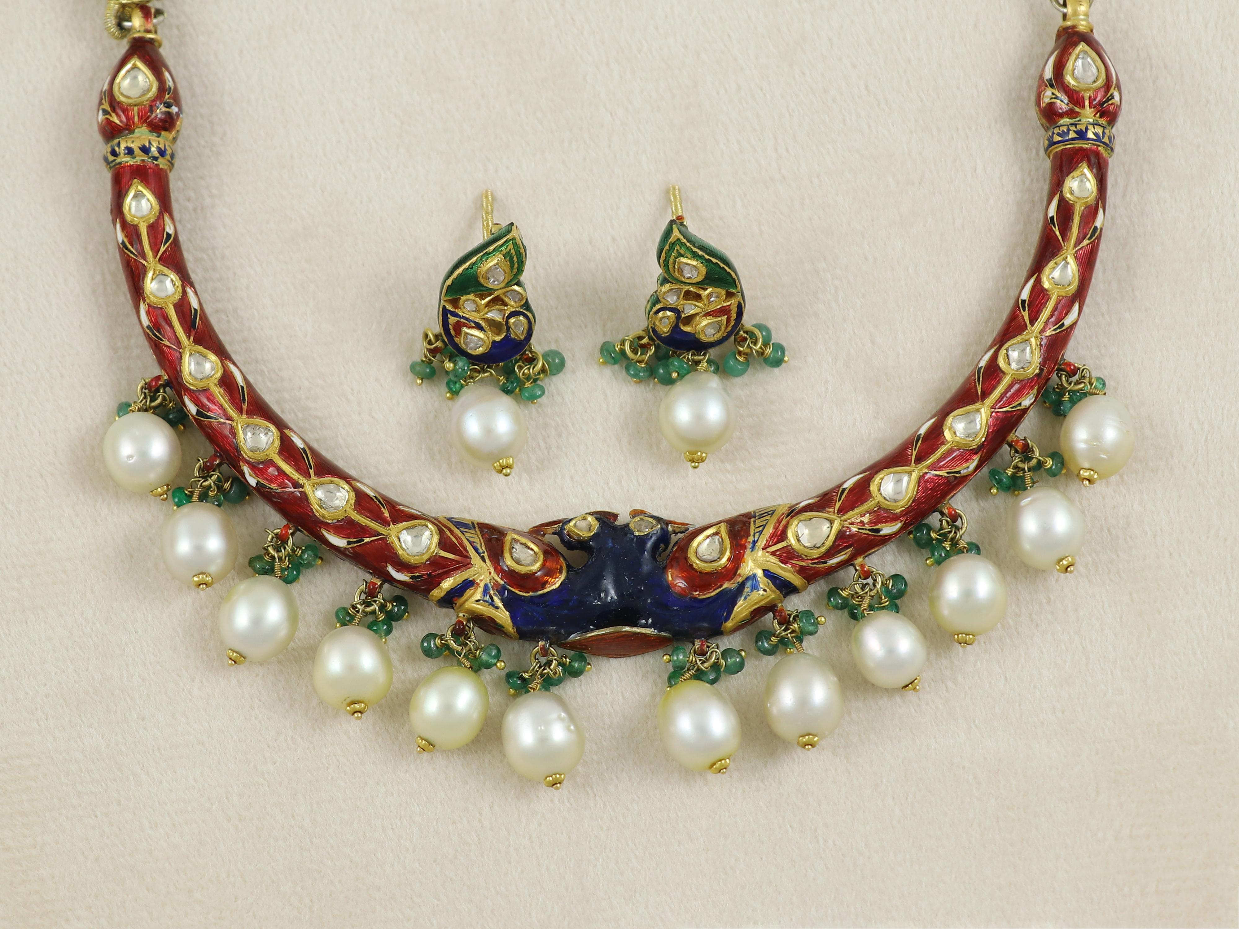 A statement necklace handcrafted in India, with more than 30 days of hand craftsmanship involved in one piece.

This mughal style necklace borrows its ethos from Indian tradition and is made in form of two peacocks coming together. The necklace has