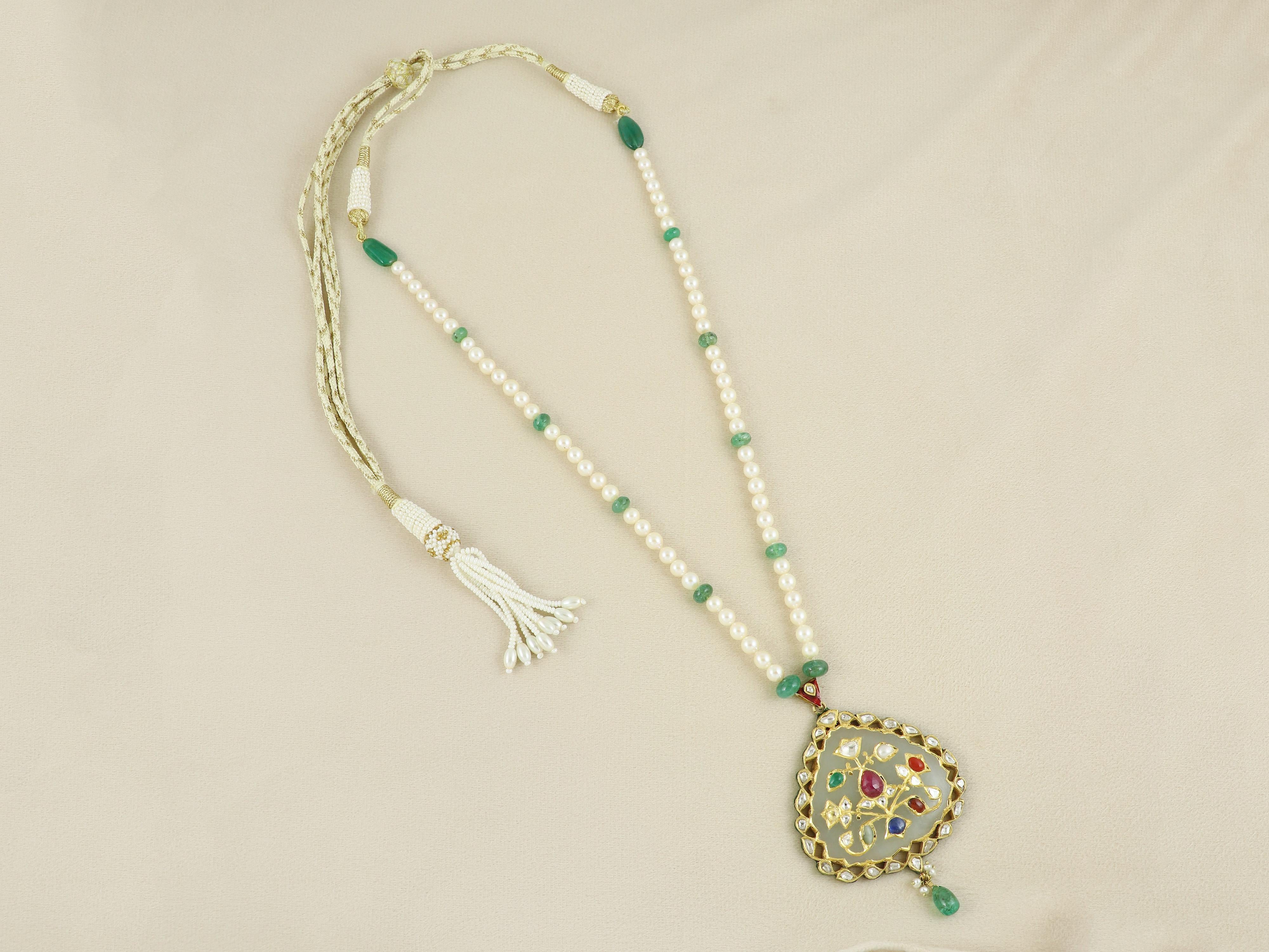 Rooted in ancient Vedic and Mughal traditions, this opulent Navratna pendant is a rare expression of balance, beauty, and spiritual symbolism. Hand-carved from rich mutton fat white nephrite jade, the centerpiece is studded with the nine sacred