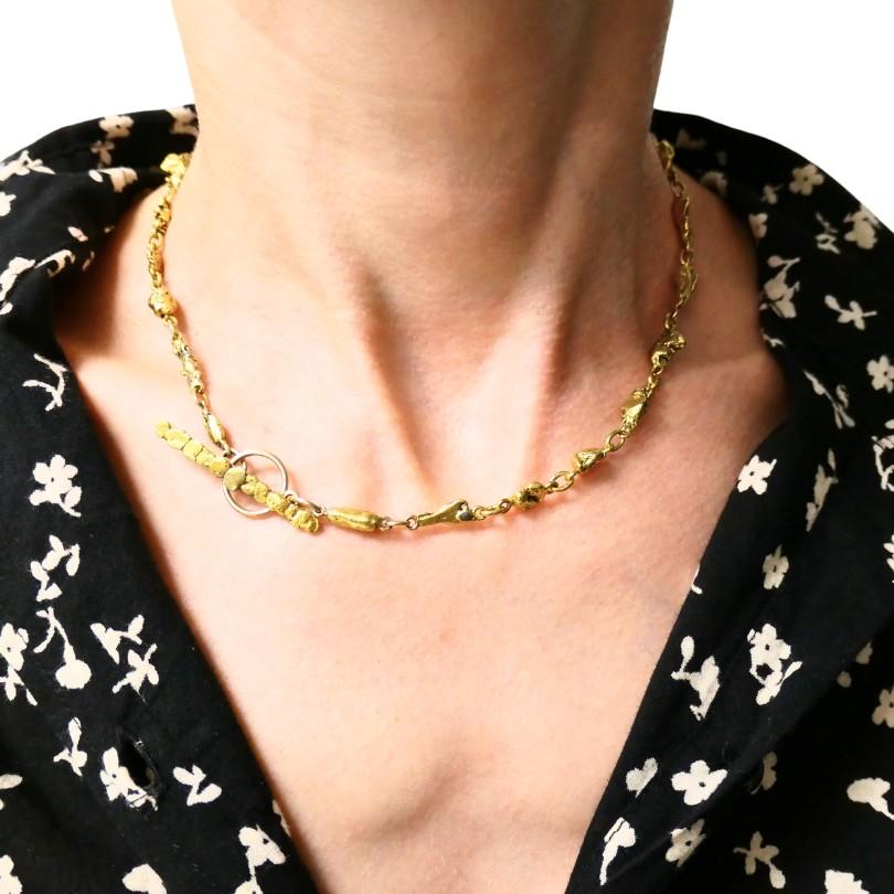 A 22k gold nugget bar necklace with a 14k gold clasp.
This vintage gold nuggets necklace featuring bars linked together in an eye-catching design.
Each nugget showcases its natural, irregular shape, adding a sense of raw beauty to this piece.
The