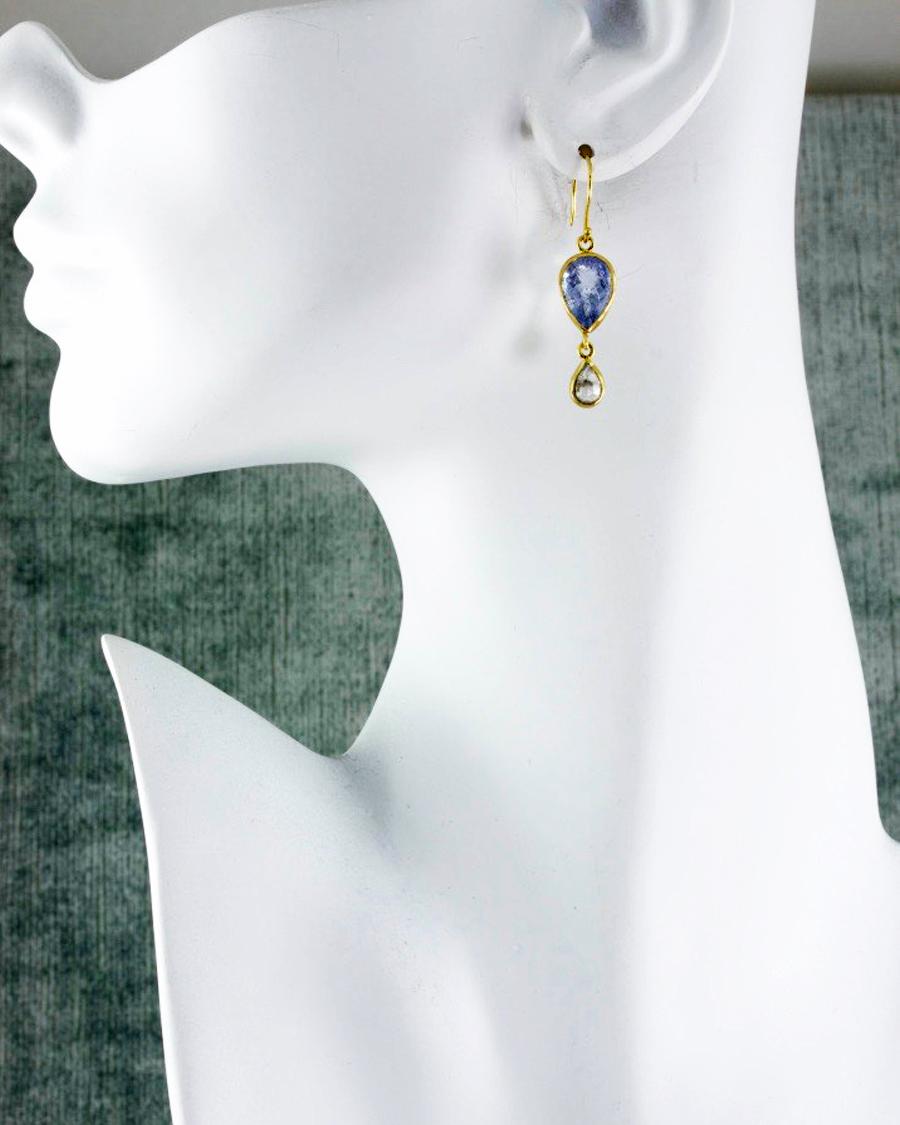 Delicate tear drops of rose cut diamonds hang beneath powder blue, checkerboard faceted beryls. Bezel set in matte 22k gold, this sweet pair has a timeless look with a modern touch.

22k recycled gold, 7.22 carats blue beryl, 1.45 carat rose cut