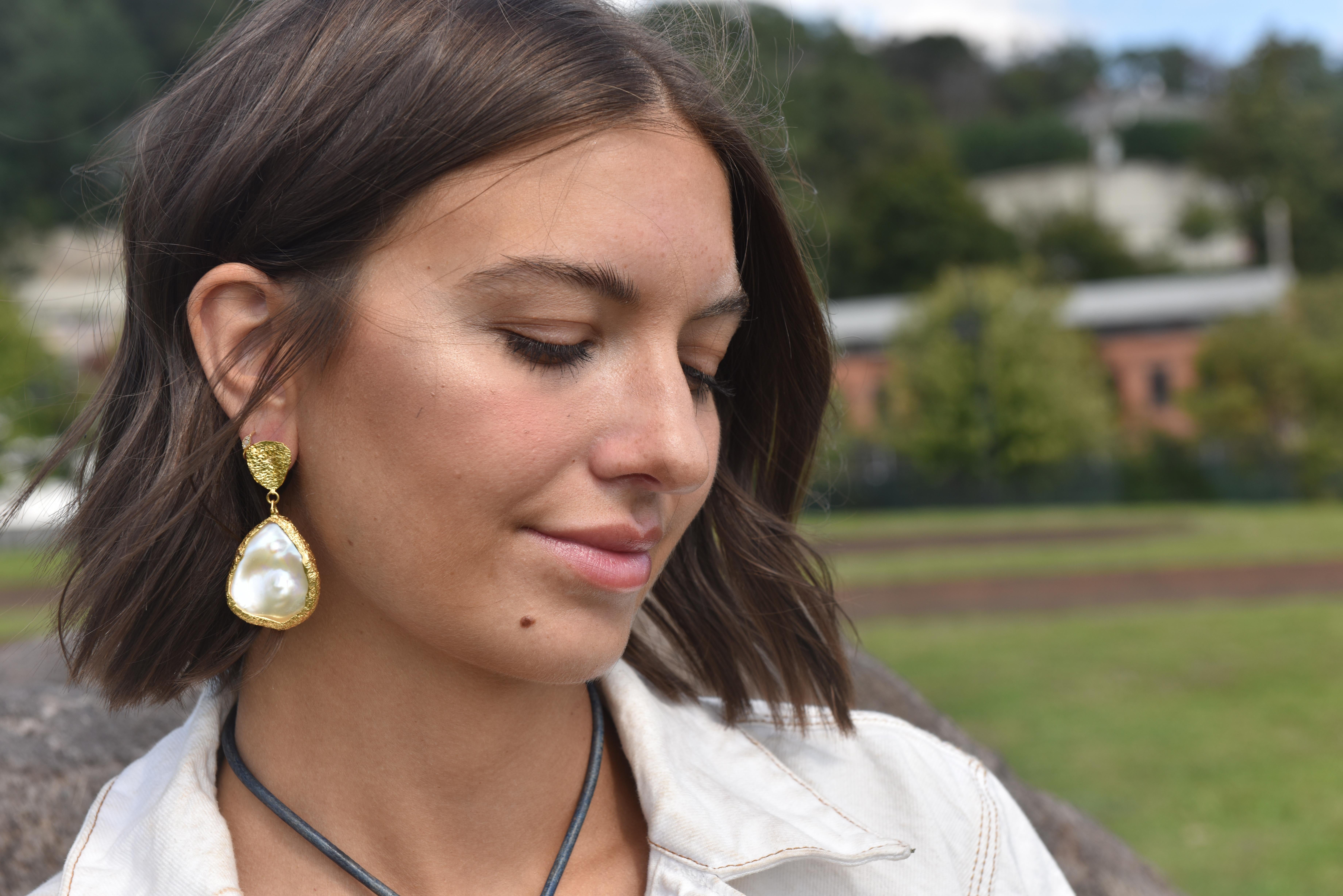 Standout with these 22k gold Pearl Teardrop Earrings. They are handmade and one of a kind complete with Tagili Designs signature finish. Stone approximately 30x25mm. The Pearl Collection represents the beauty, uniqueness and power of a woman.