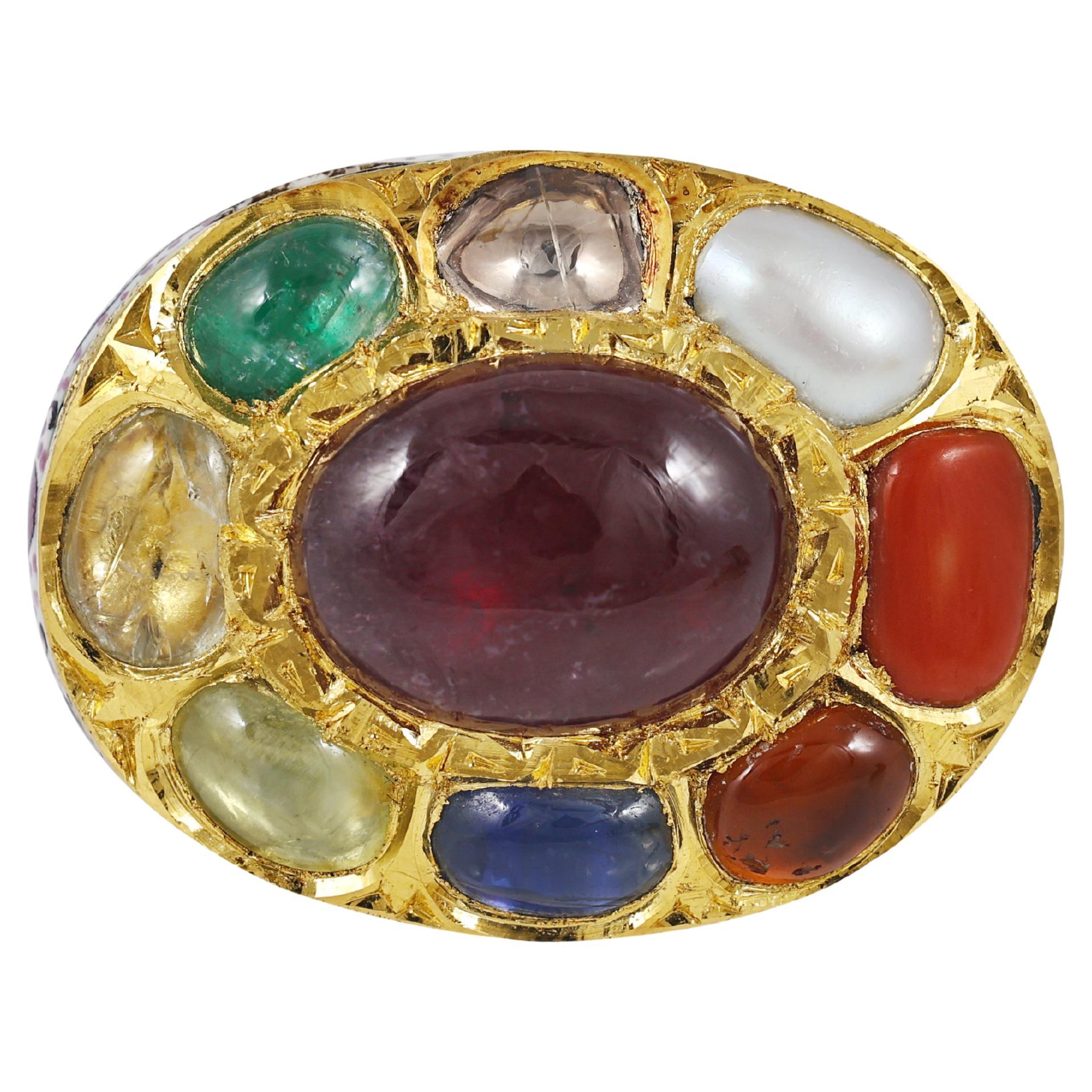 A 22K gold ring decorated with Indian Benarasi Meena (enamel) and studded with nine precious natural gemstones including diamond.

The enamel on this ring is an old art which comes from benares school of art from India. The enamel done is a painting