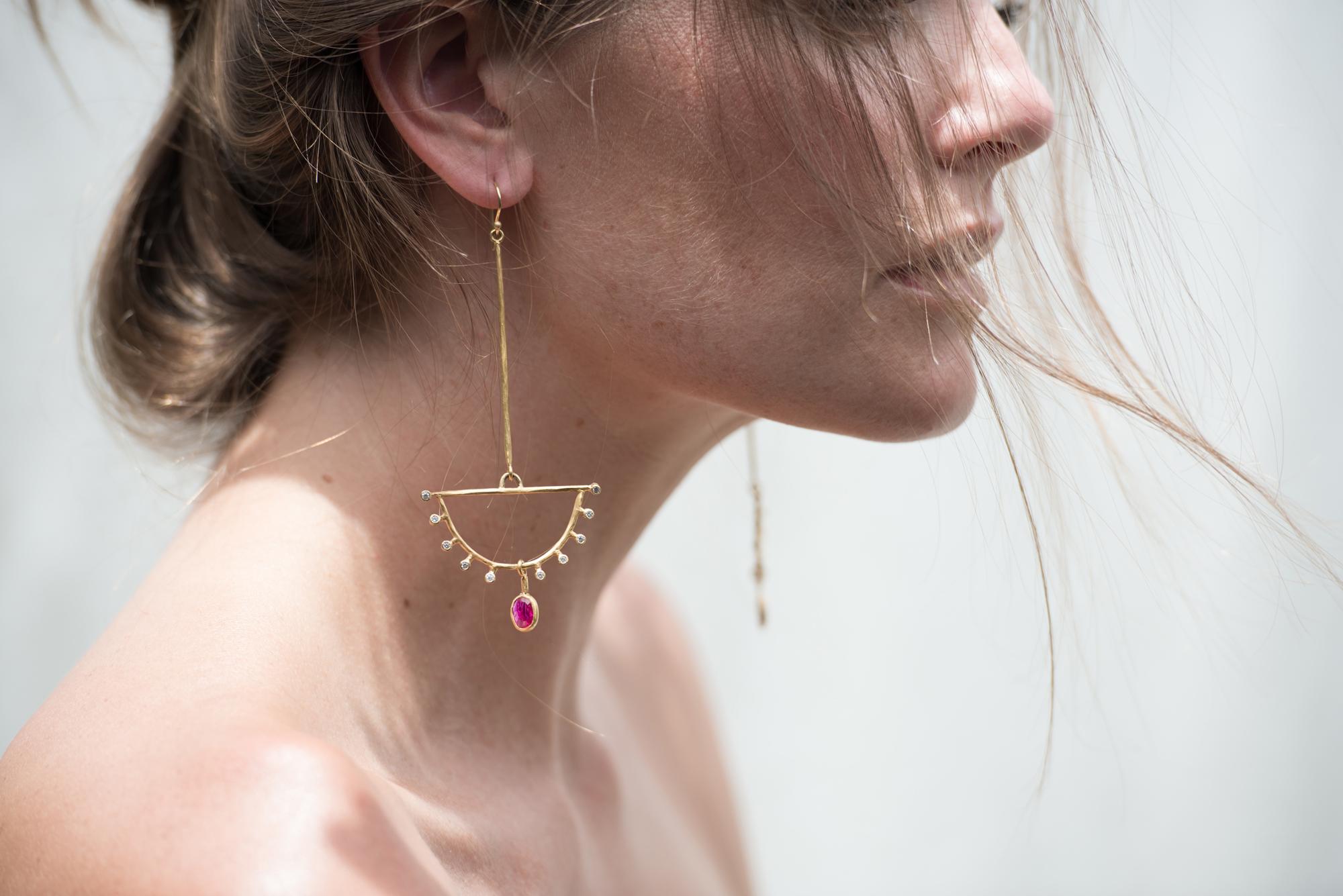 A beautifully hued, rose cut, Mozambique ruby sways freely from the inverted diamond studded fan.  This pair is extremely comfortable to wear and adds just the right amount of sparkle and pop of color.  Handcrafted of rich 22k yellow gold, each